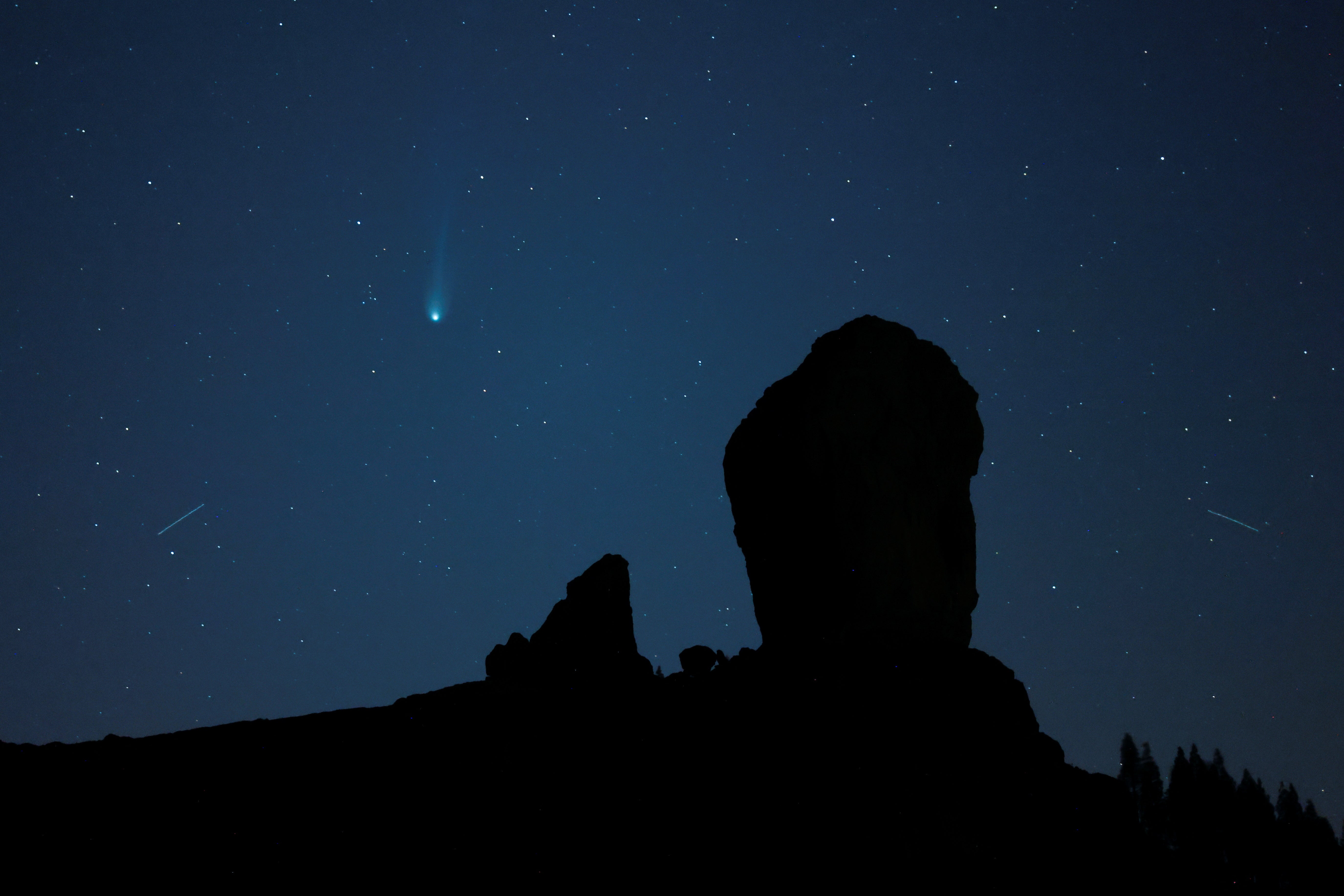 Comet 12P/Pons-Brooks is photographed over the Roque Nublo Natural Monument in Tejeda, on Gran Canaria Island