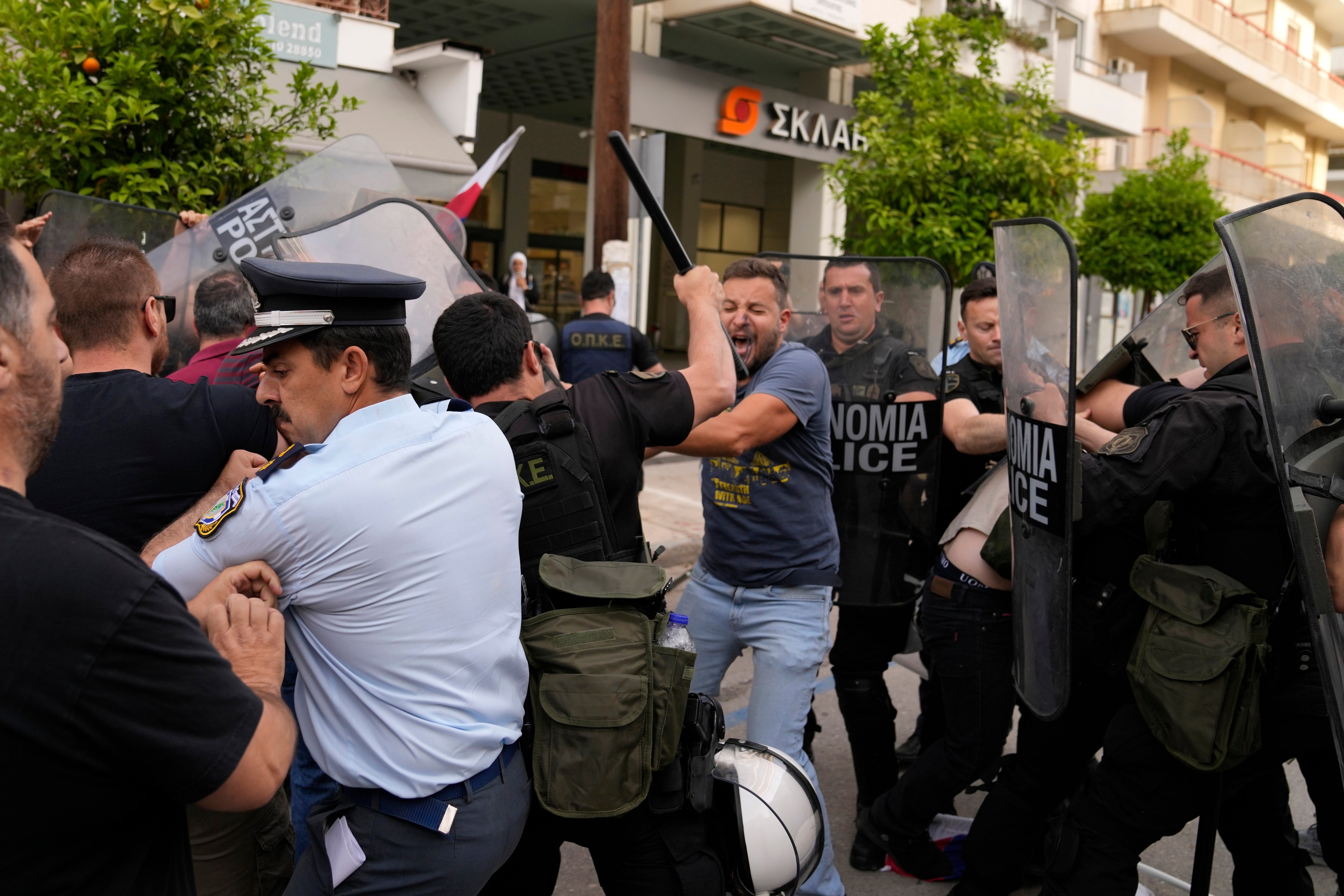 Police clash with protesters outside a court house in Kalamata, southwestern Greece, on Tuesday, May 21, 2024