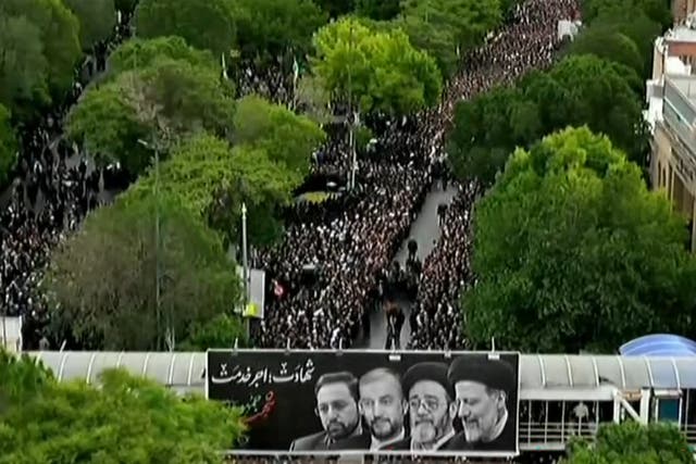 <p>This grab taken from handout video footage released by Iran Press on May 21, 2024 shows people gathering to mourn the Iranian President and seven members of his entourage during a funerary procession</p>