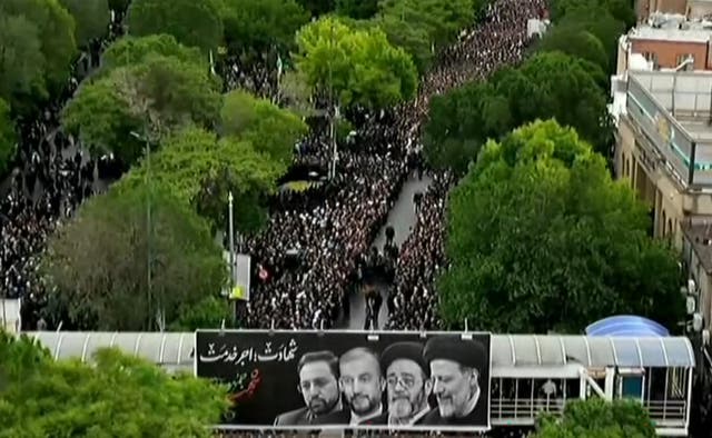 <p>This grab taken from handout video footage released by Iran Press on May 21, 2024 shows people gathering to mourn the Iranian President and seven members of his entourage during a funerary procession</p>