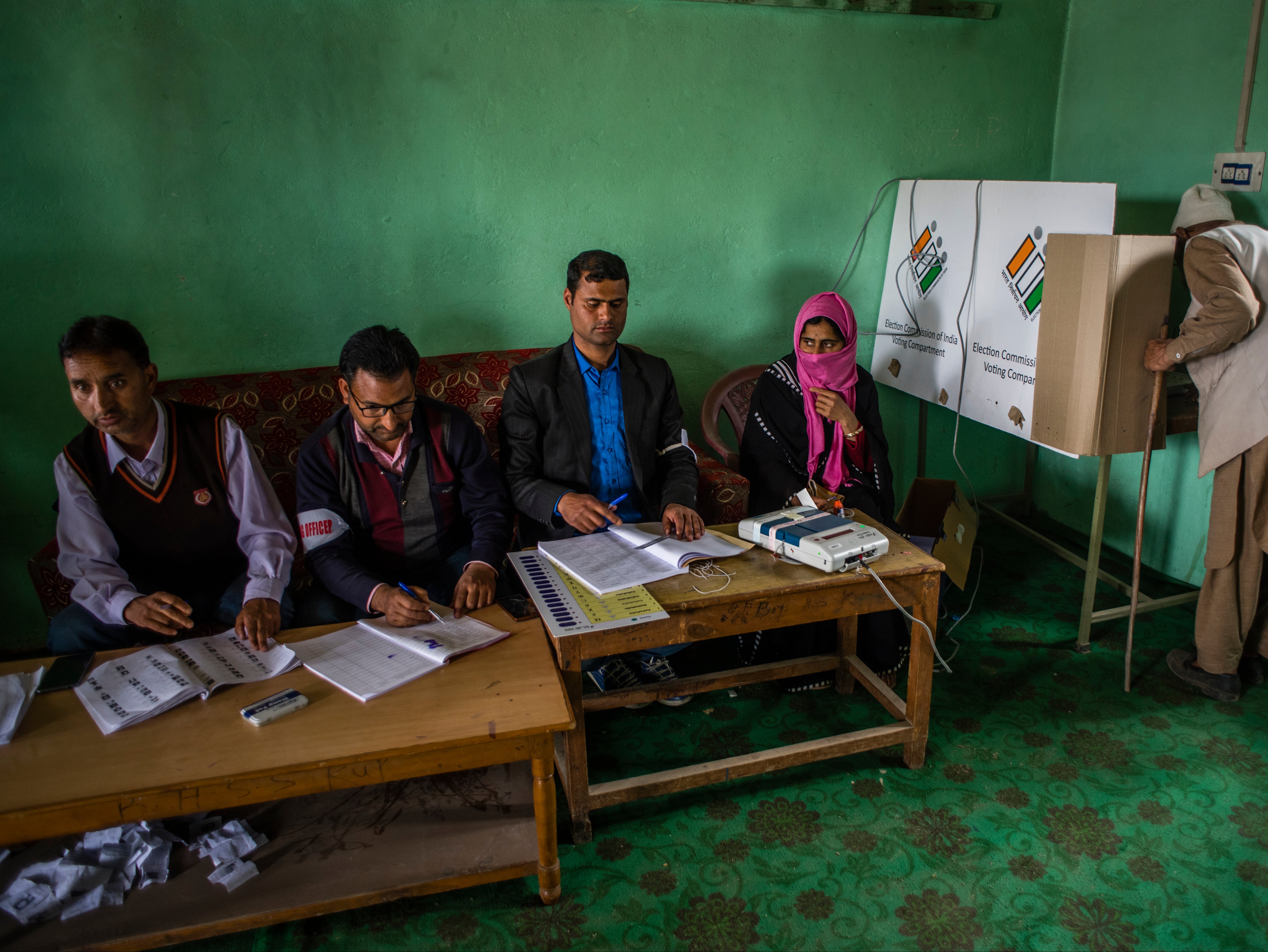 An elderly Kashmiri Muslim man casts his vote inside a polling station in Kupwara, 90km north of Srinagar, the summer capital of Indian-administered Kashmir