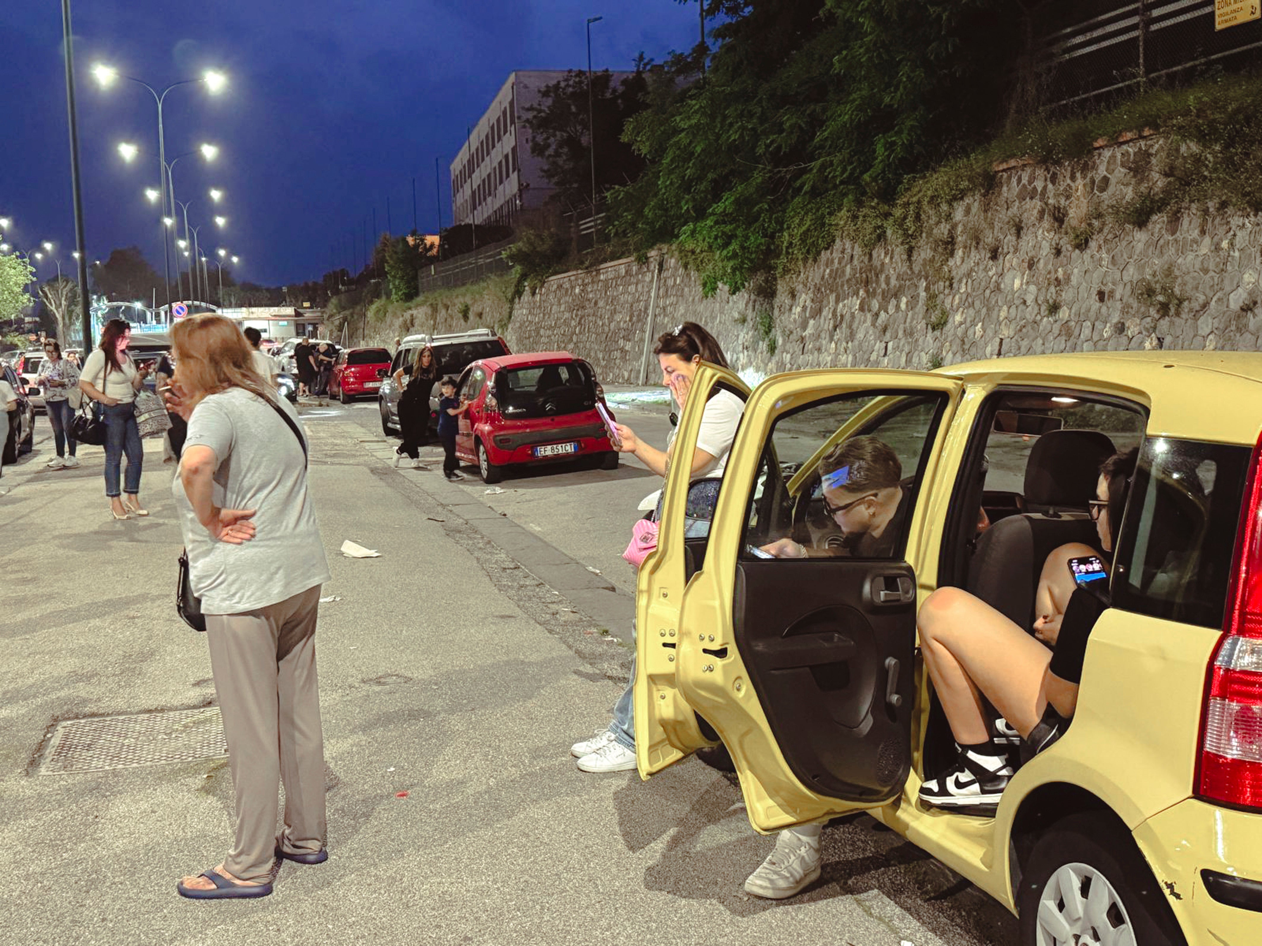 People gather in a street after an earthquake in Campi Flegrei, near Naples, Italy, Tuesday, May 20, 2024