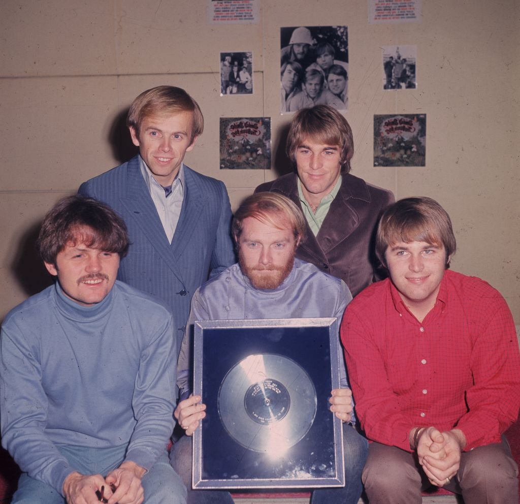 The Beach Boys: Bruce Johnston, Al Jardine, Mike Love (holding the disc)) Dennis Wilson(1944 - 1983) and bottom right, Carl Wilson (1946 - 1999)