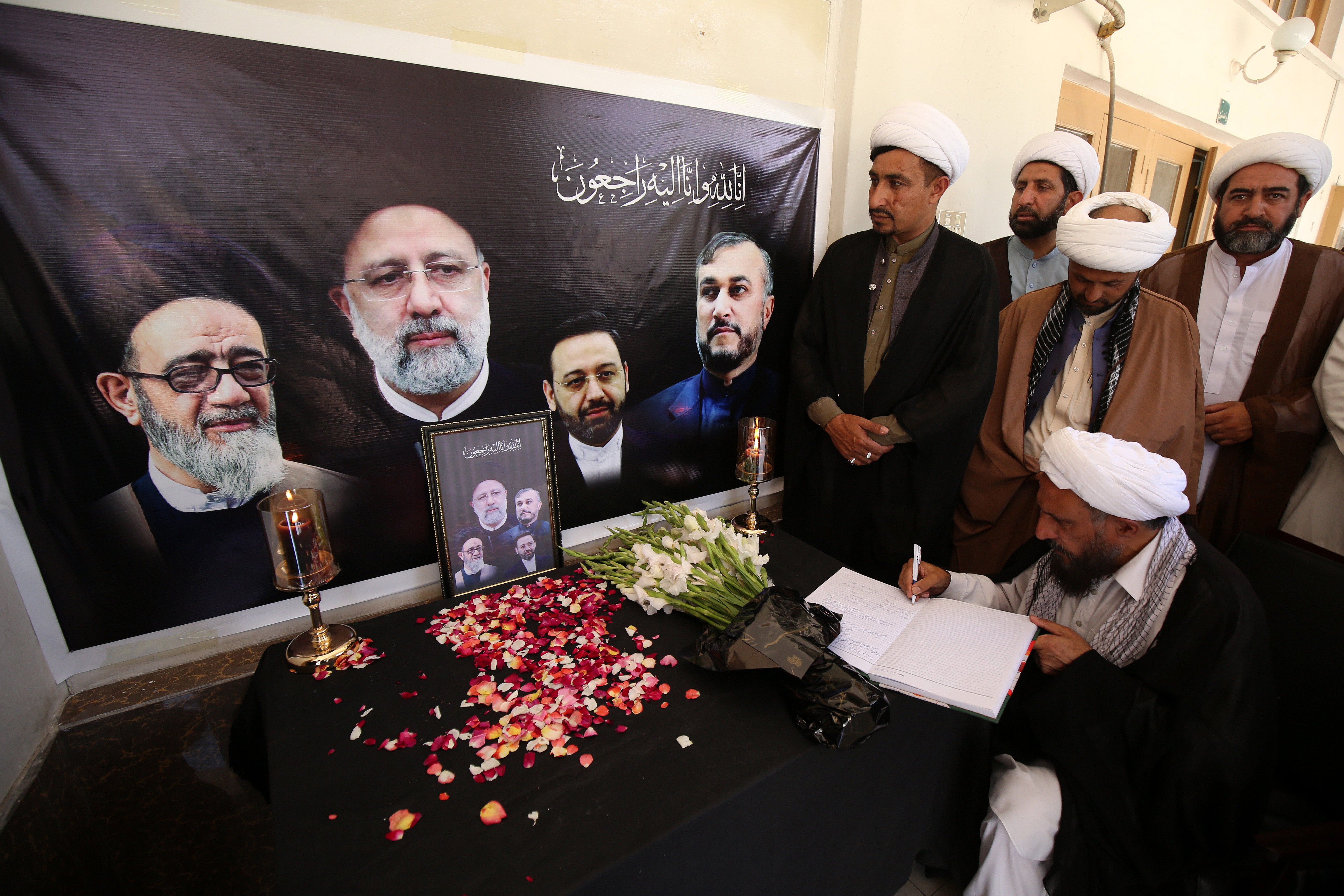 A visitor signs a condolence book at the Khana-e-Farhang Iranian culture centre following the deaths of Iran's president Raisi and Foreign Minister Amir-Abdollahian, in Peshawar, Pakistan