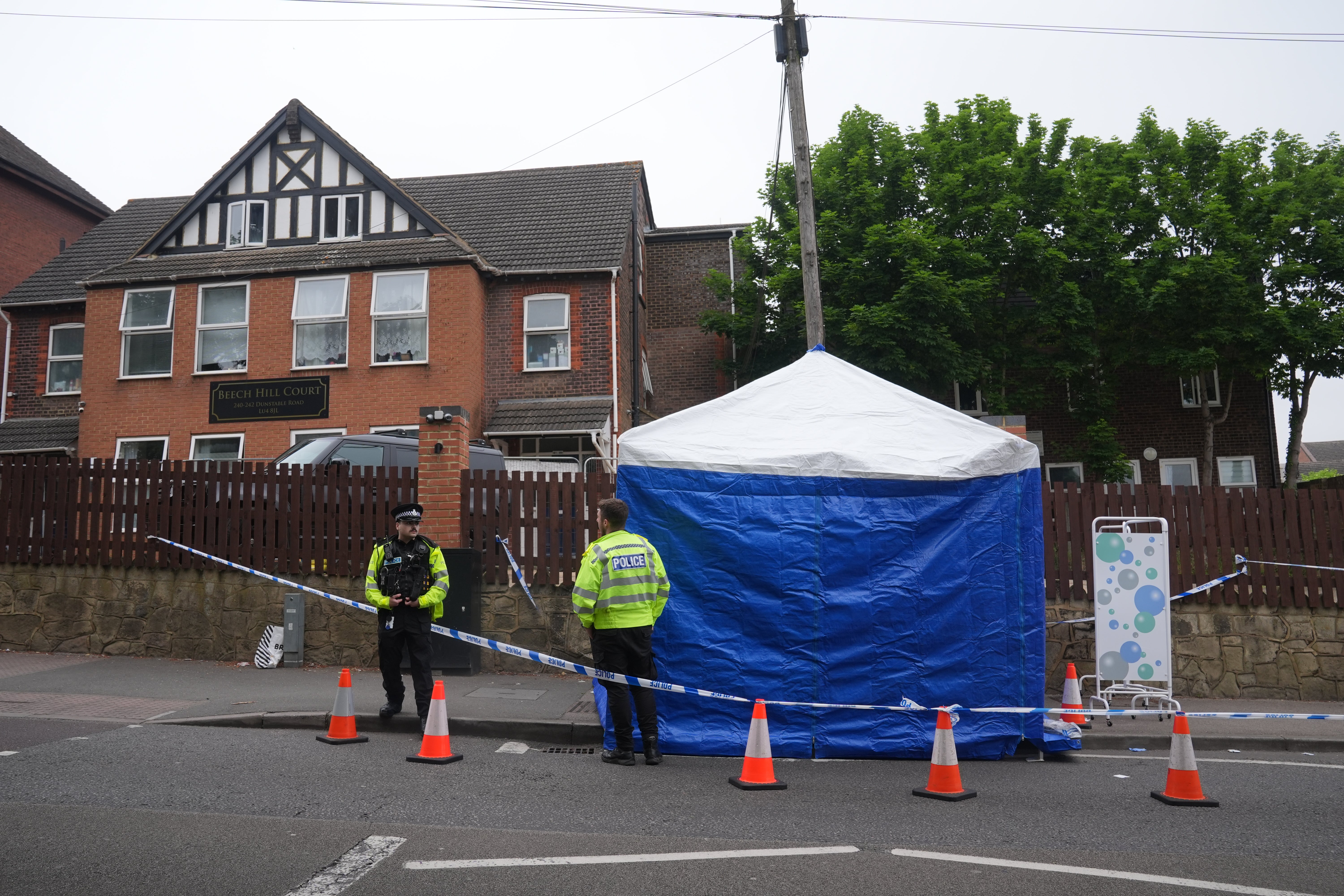 A forensics tent and officers in the street following the attack