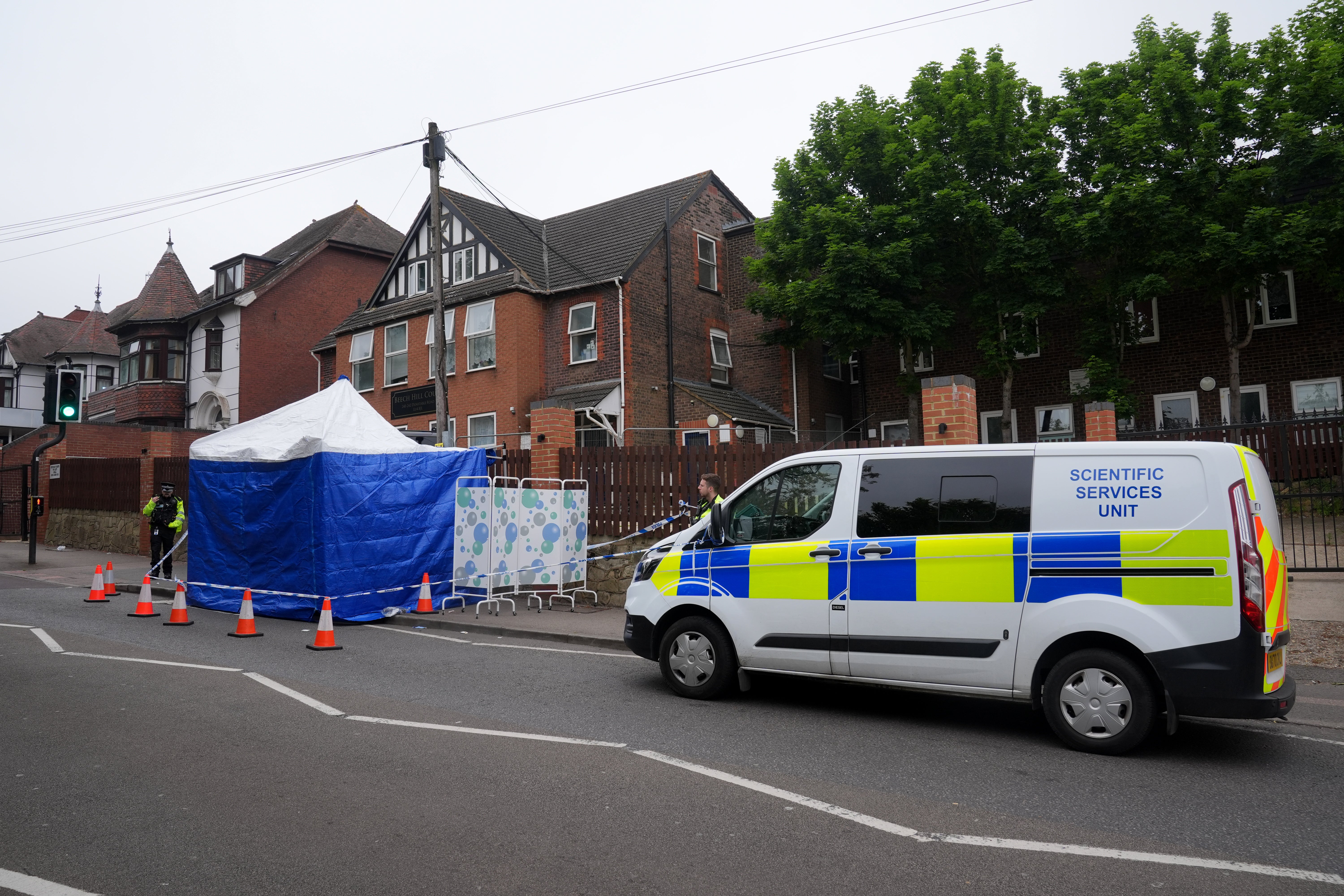Police at the scene of the stabbing in Dunstable Road