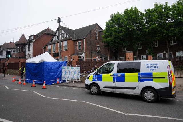 <p>Police at the scene of the stabbing in Dunstable Road </p>