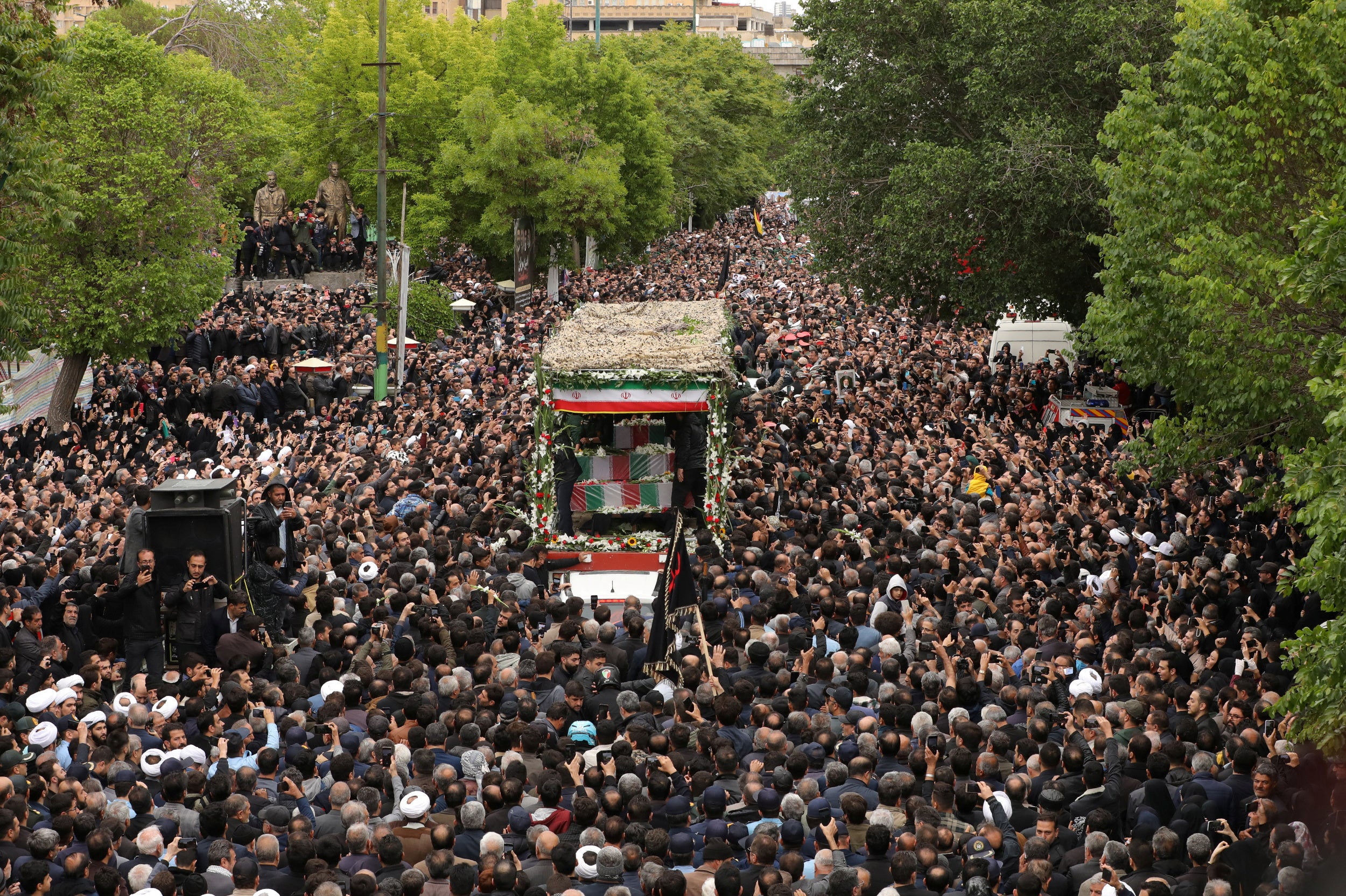 Thousands swarm a truck carrying Ebrahim Raisi’s body through the city of Tabriz