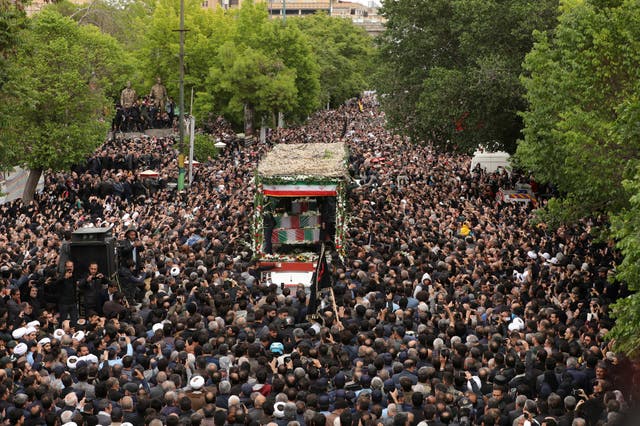 <p>Thousands swarm a truck carrying  Ebrahim Raisi’s body through the city of Tabriz </p>