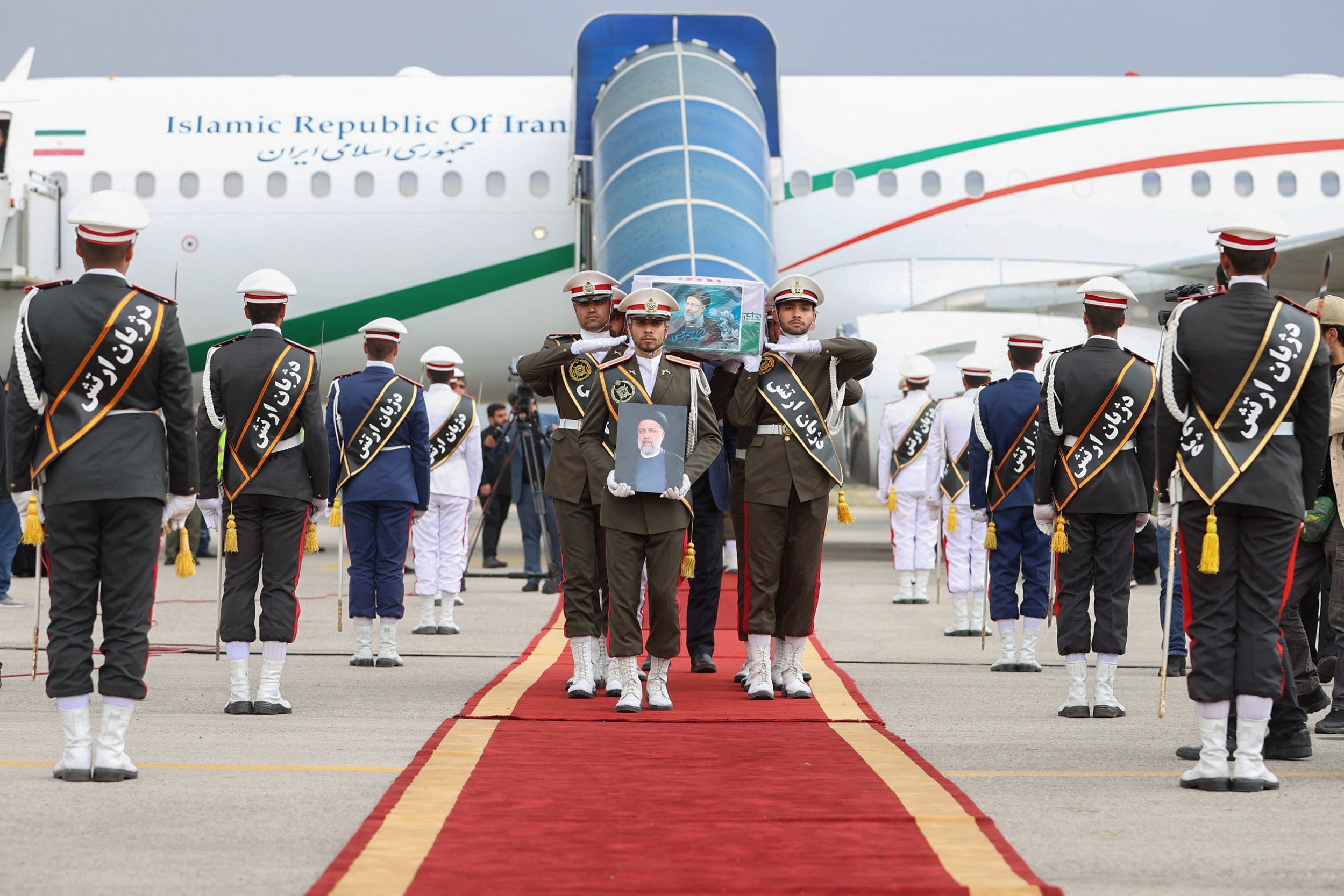 Soldiers carry the coffin of the late Iranian President Ebrahim Raisi at Mehrabad Airport in Tehran