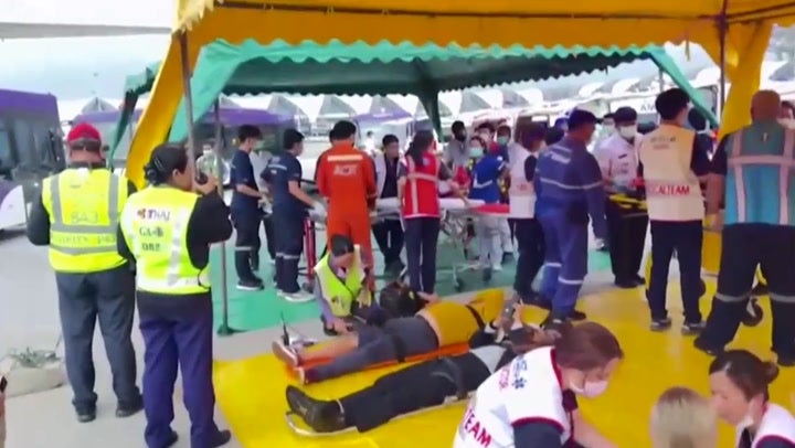 Injured passengers being treated on the airport tarmac in Bangkok after the London to Singapore flight hit severe turbulence and was forced to divert