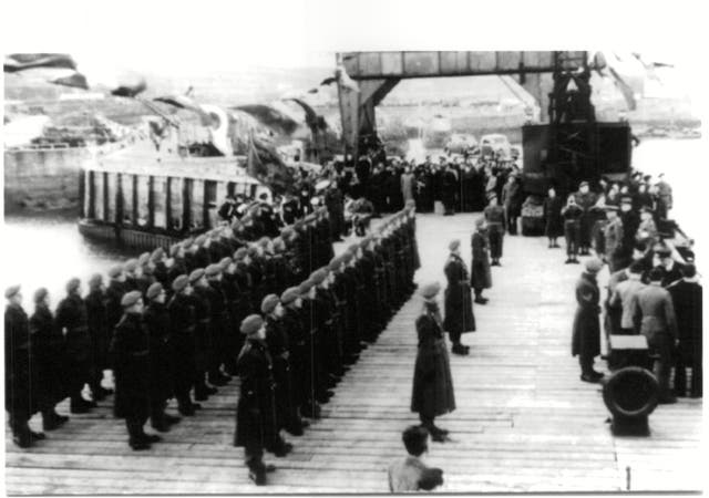 <p>The British garrison welcomes the returning islanders who evacuated prior to the Nazi occupation in 1940</p>