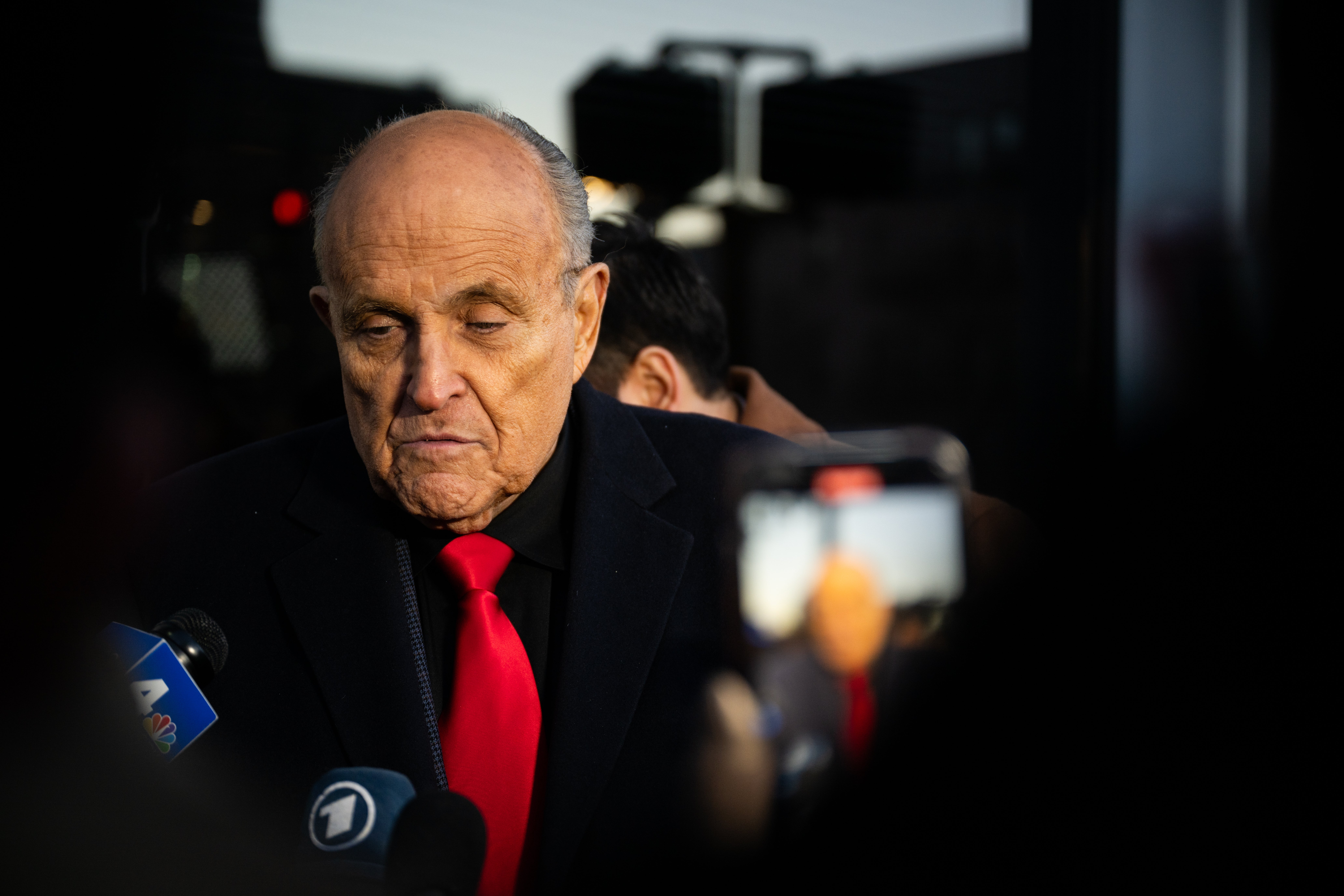 Rudy Giuliani, pictured speaking to reporters in January, pleaded not guilty after prosecutors say he participated in the 2020 Arizona fake electors scheme