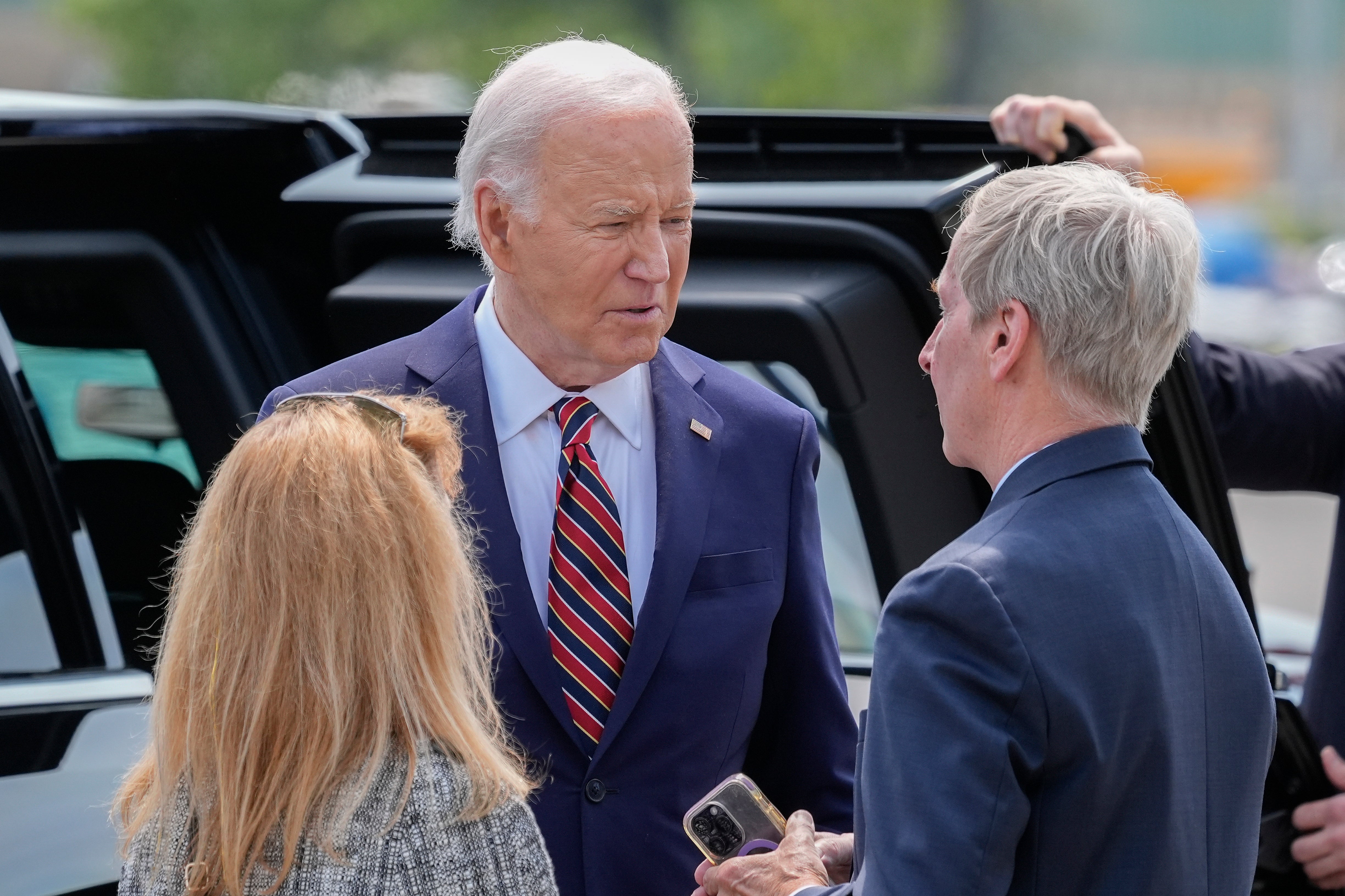 President Joe Biden, center, talks with John Lynch, former Governor of New Hampshire, right, and Lynch's spouse Dr. Susan Lynch, left, on the tarmac during Air Force One arrival at Manchester-Boston Regional Airport, Tuesday, May 21, 2024, in Manchester, N.H. (AP Photo/Alex Brandon)