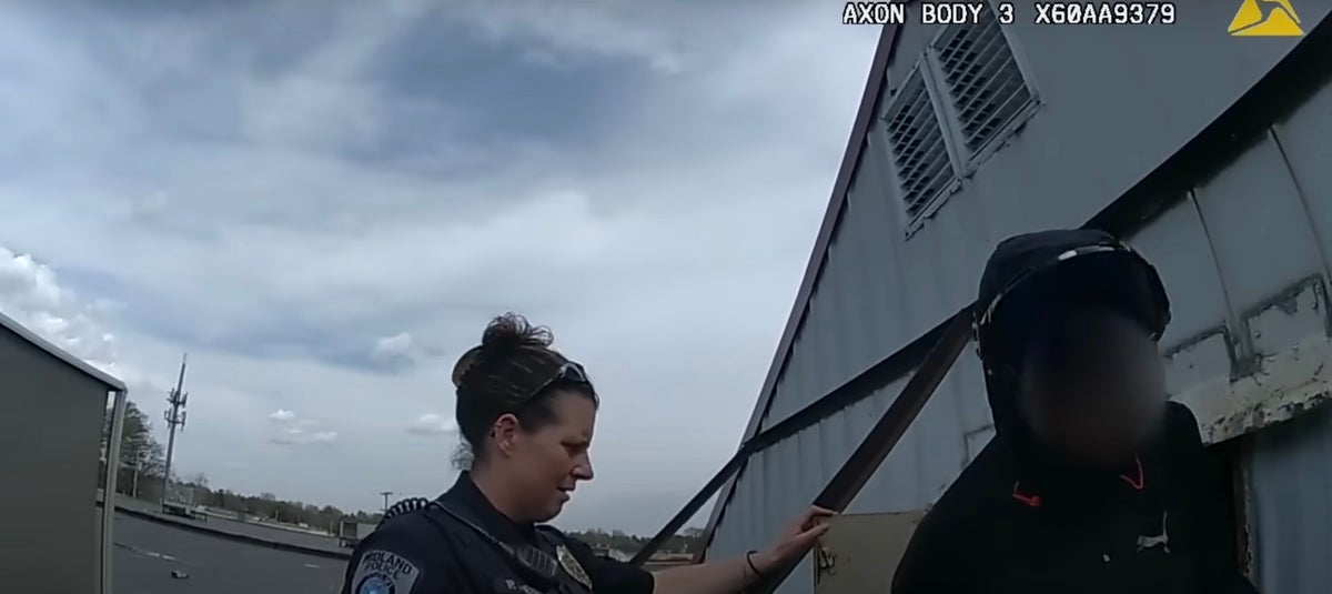 Moment police confront woman living in grocery store roof sign