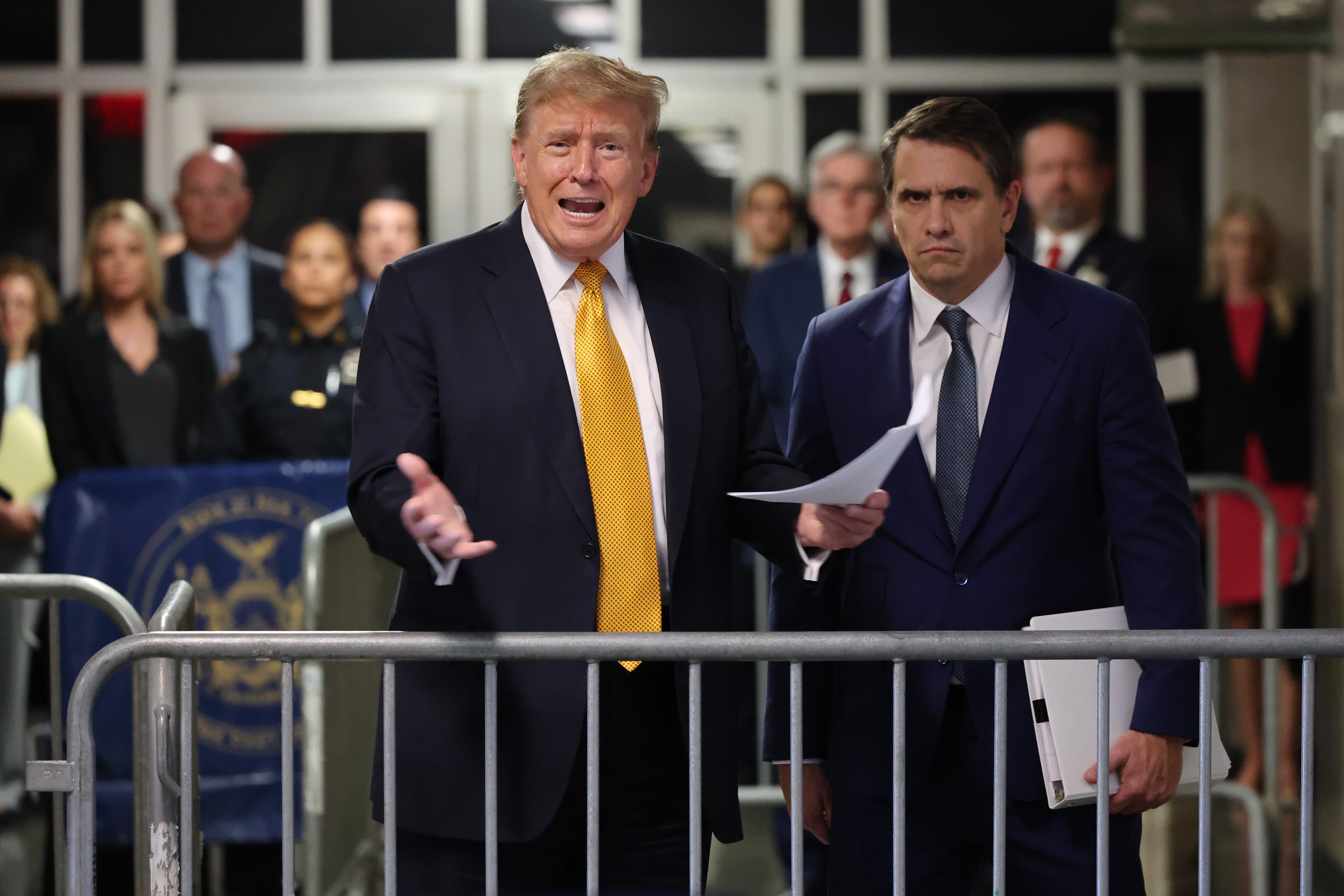 Former US President Donald Trump (L) speaks to the press alongside his attorney Todd Blanche (R) at the end of the day at his hush money criminal trial at New York State Supreme Court in New York