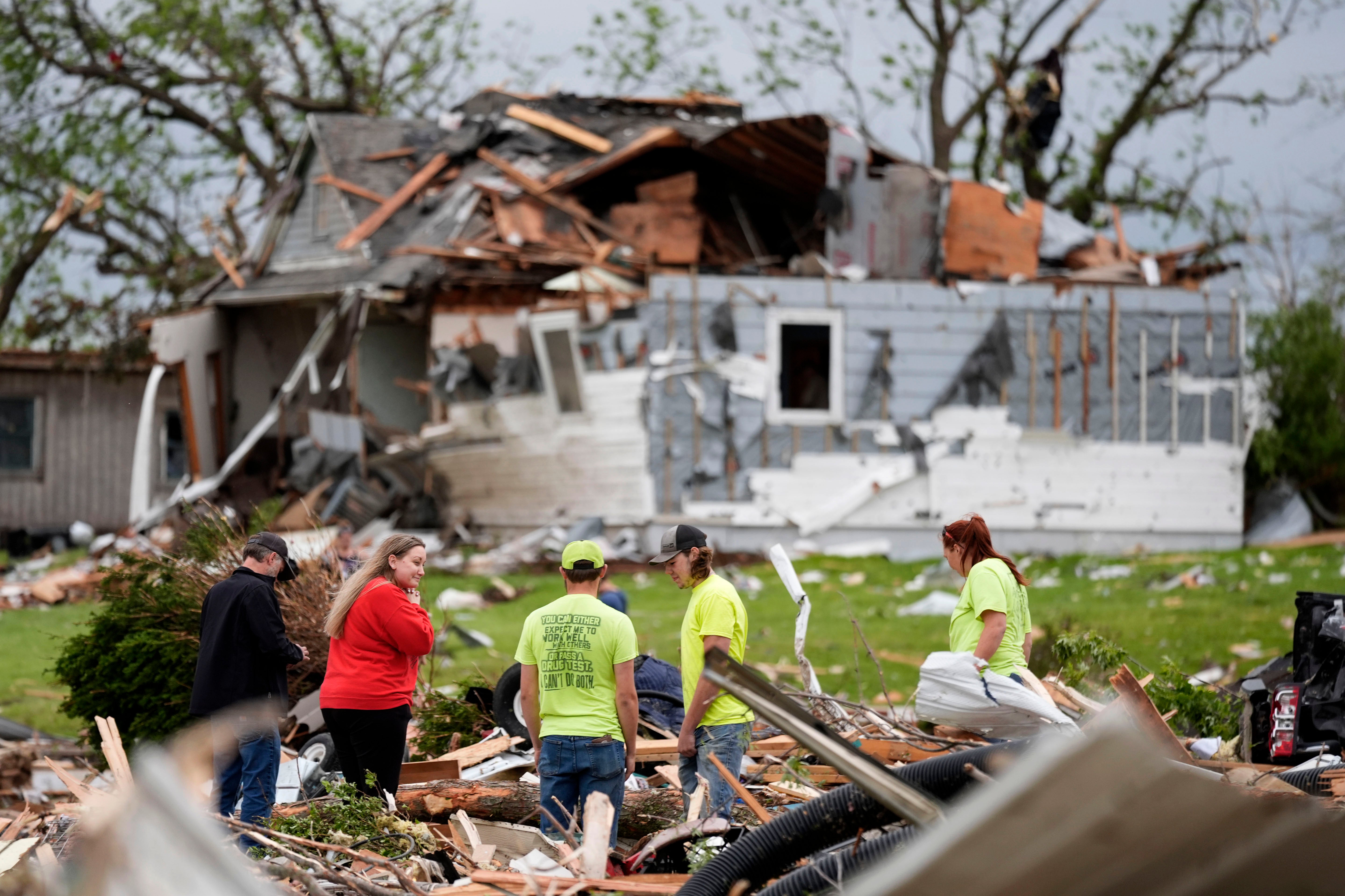 Residents sort through tornado wreckage in Greenfield, Iowa, on Tuesday. Multiple people in the small town are dead after the destructive twister hit their town