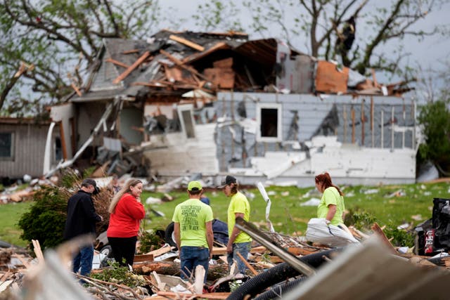 <p>Residents sort through tornado wreckage in Greenfield, Iowa, on Tuesday. Multiple people in the small town are dead after the destructive twister hit their town</p>