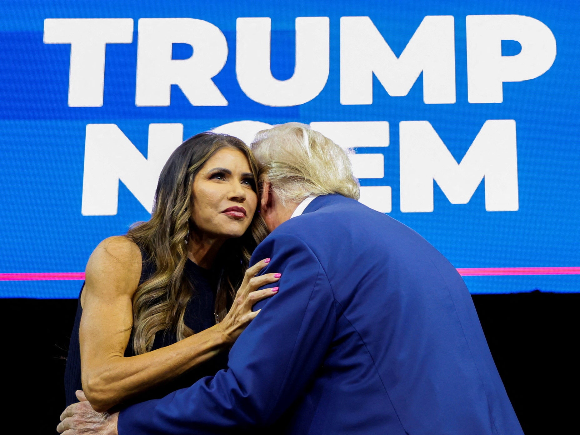 South Dakota Governor Kristi Noem hugs Donald Trump at a campaign rally in September 2023.