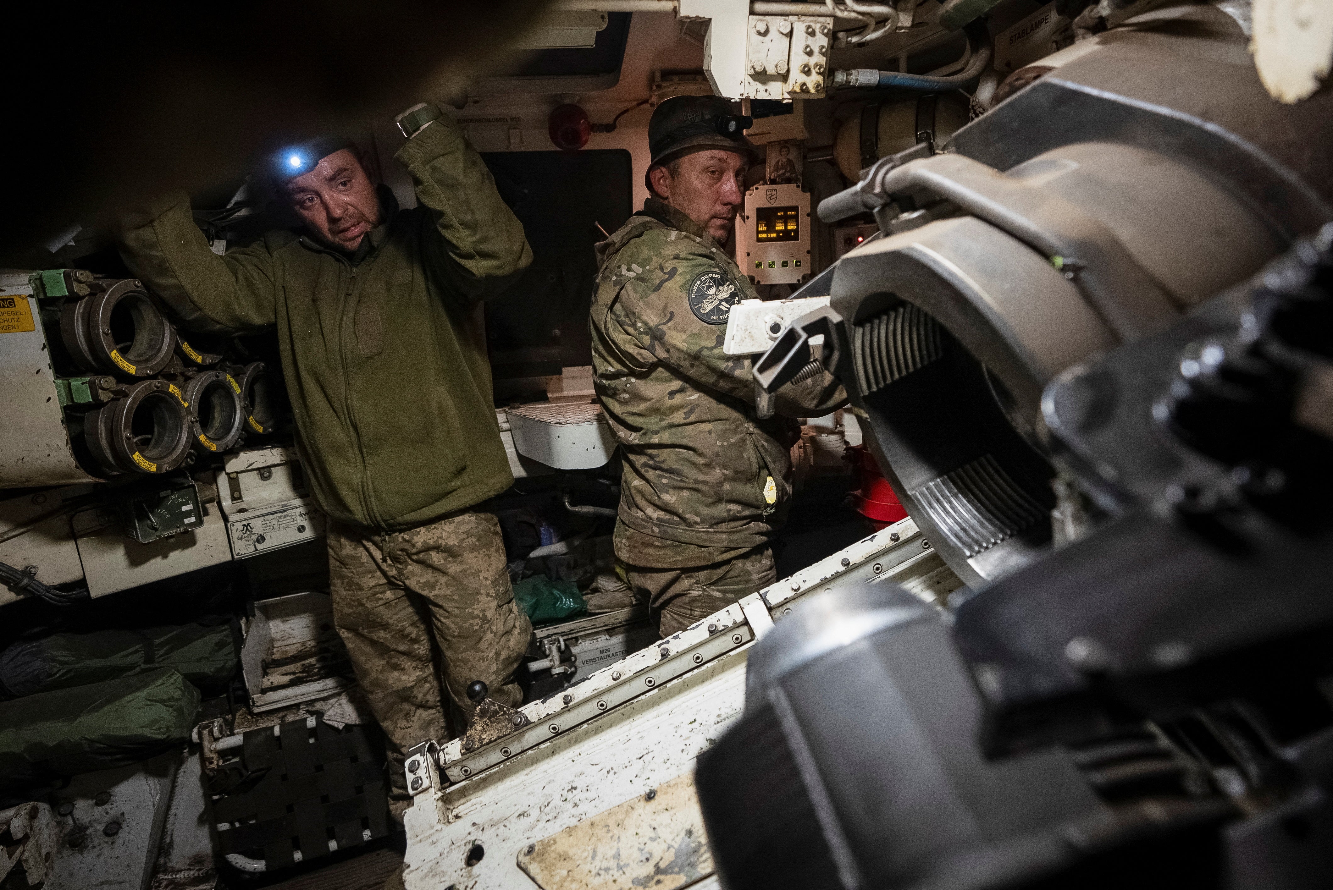 Ukrainian servicemen of the 92nd separate assault brigade prepare a M109 self-propelled howitzer to fire towards Russian troops near the town of Vovchansk in Kharkiv region