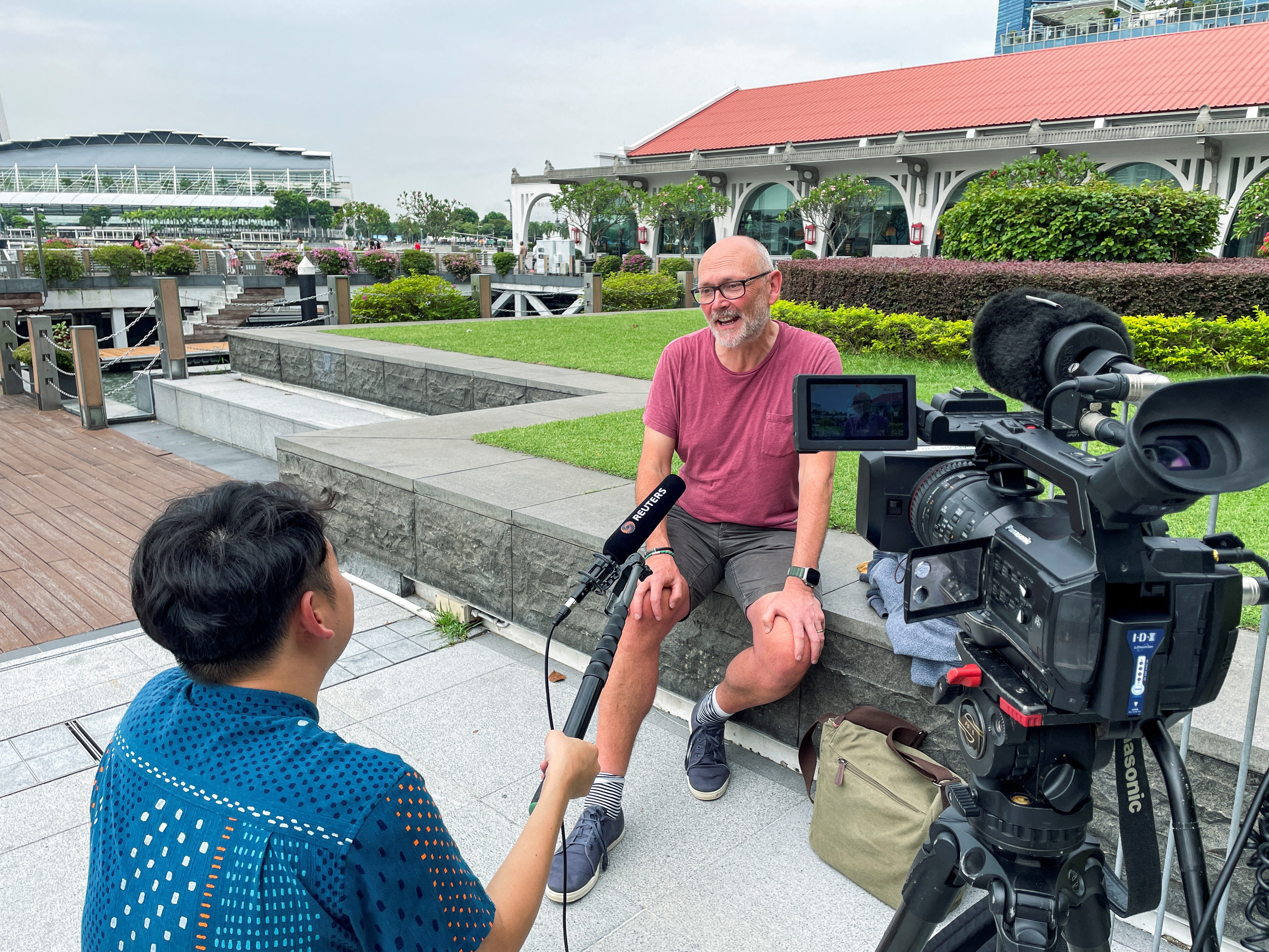 Andrew Davies, from south London, holds a press conference with reporters in Bangkok