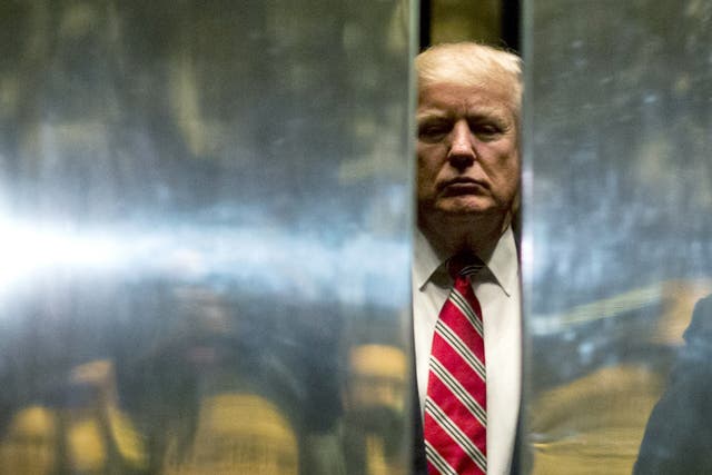 <p>US President-elect Donald Trump boards the elevator at Trump Tower in New York City on January 16, 2017</p>