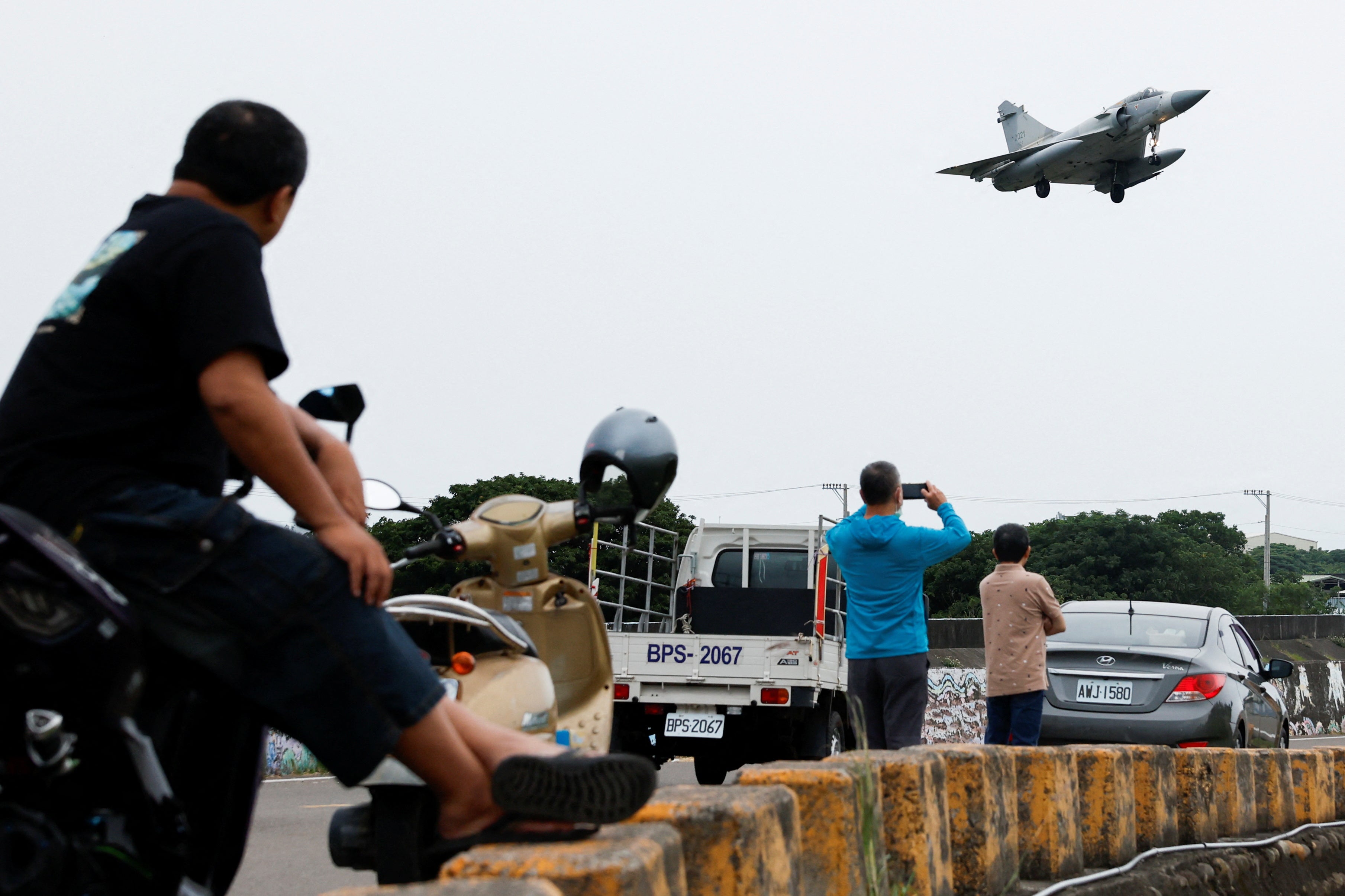 People look at a Taiwan Air Force Mirage 2000-5 aircraft as it prepares to land at Hsinchu Air Base in Hsinchu, Taiwan 23 May 2024