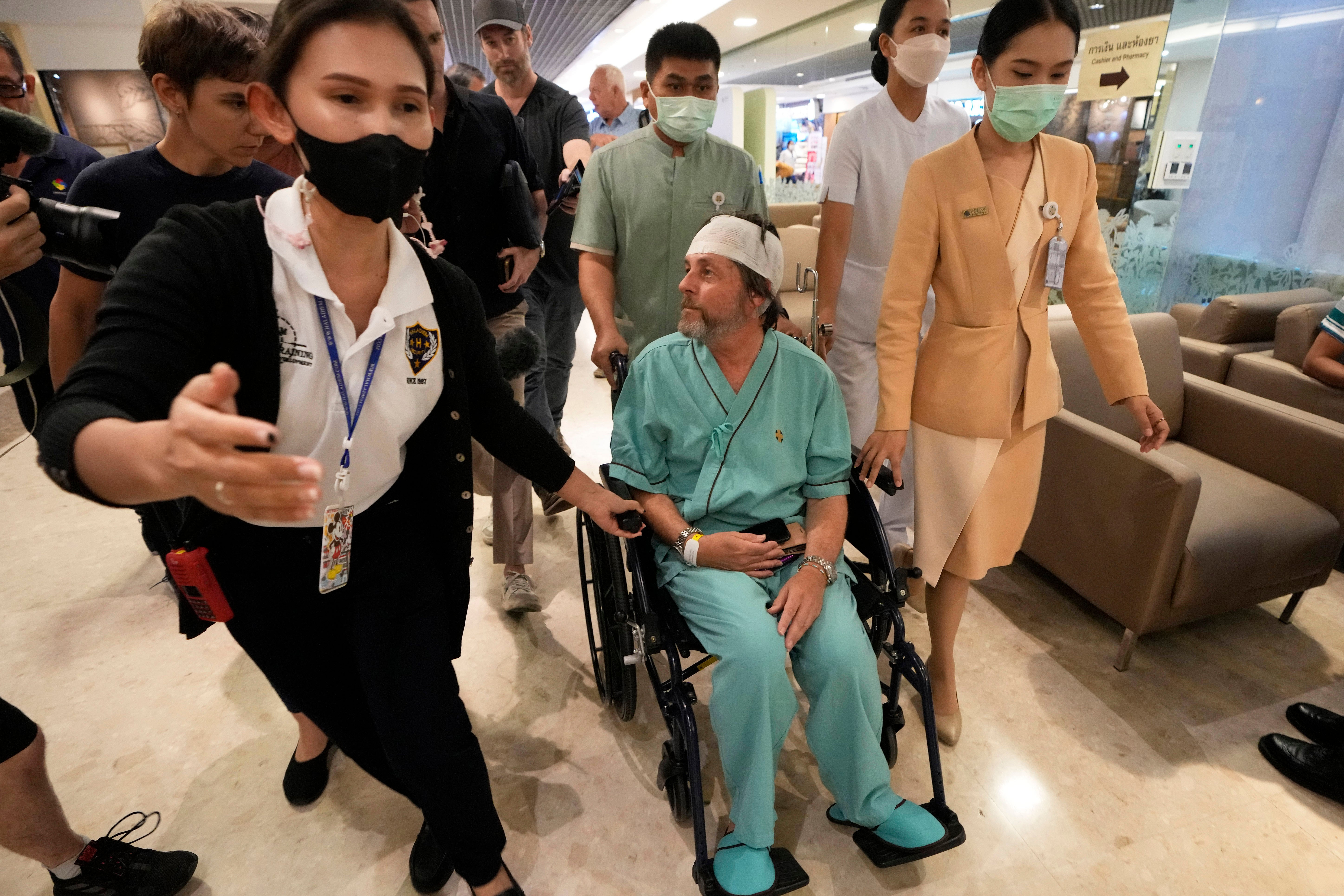 An Australian passenger injured on a Singapore Airlines flight battered by severe turbulence talks to reporters at Samitivej Srinakarin Hospital in Bangkok