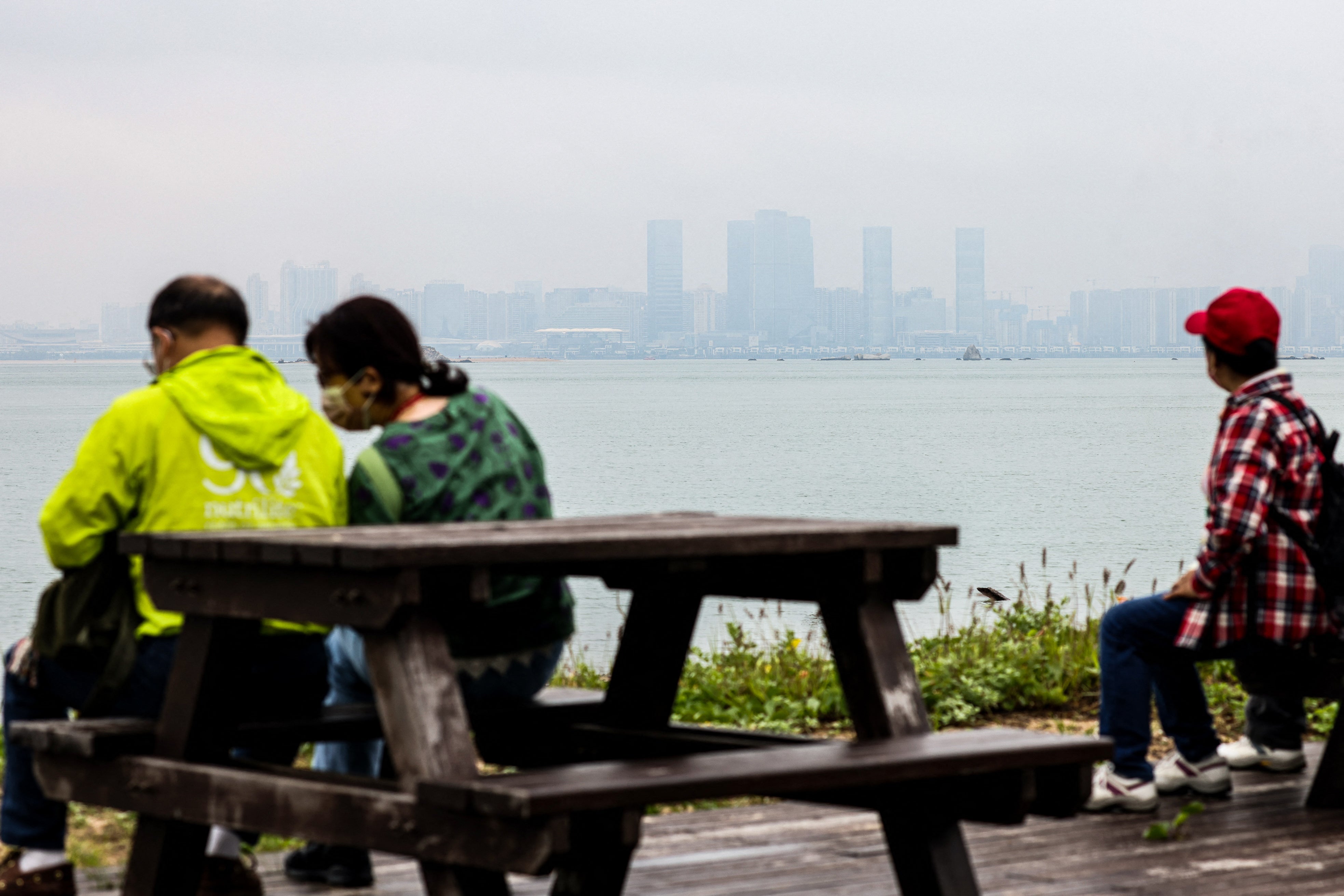 Tourists look over at the Chinese city of Xiamen from Shuang Kou Coastal Park in Kinmen on 23 May 2024