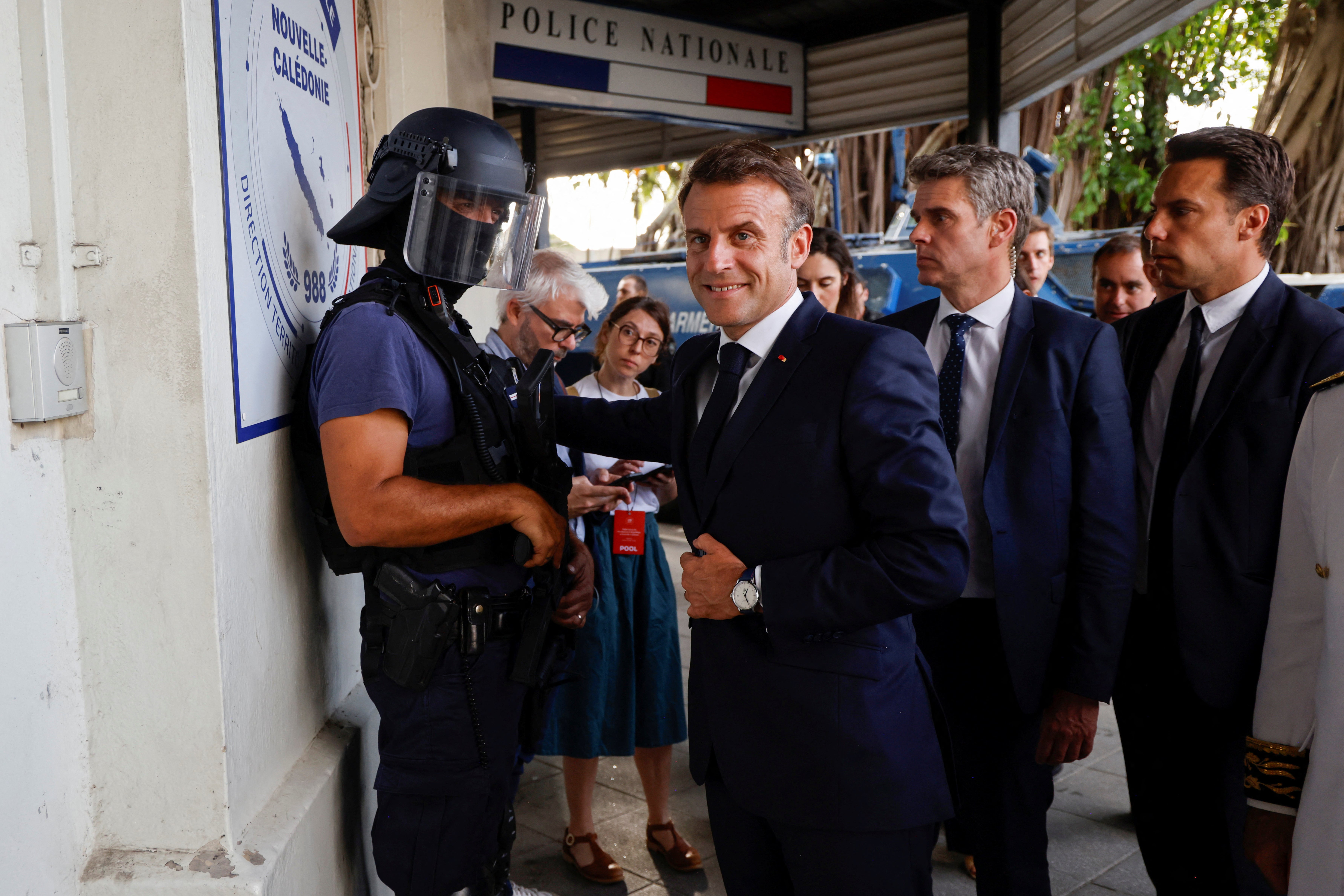 French president Emmanuel Macron arrives at the central police station in Noumea