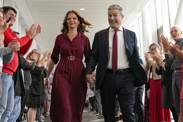 <p>Sir Keir Starmer and his wife Lady Victoria walk hand in hand after his speech at the Labour Party conference in 2022 </p>