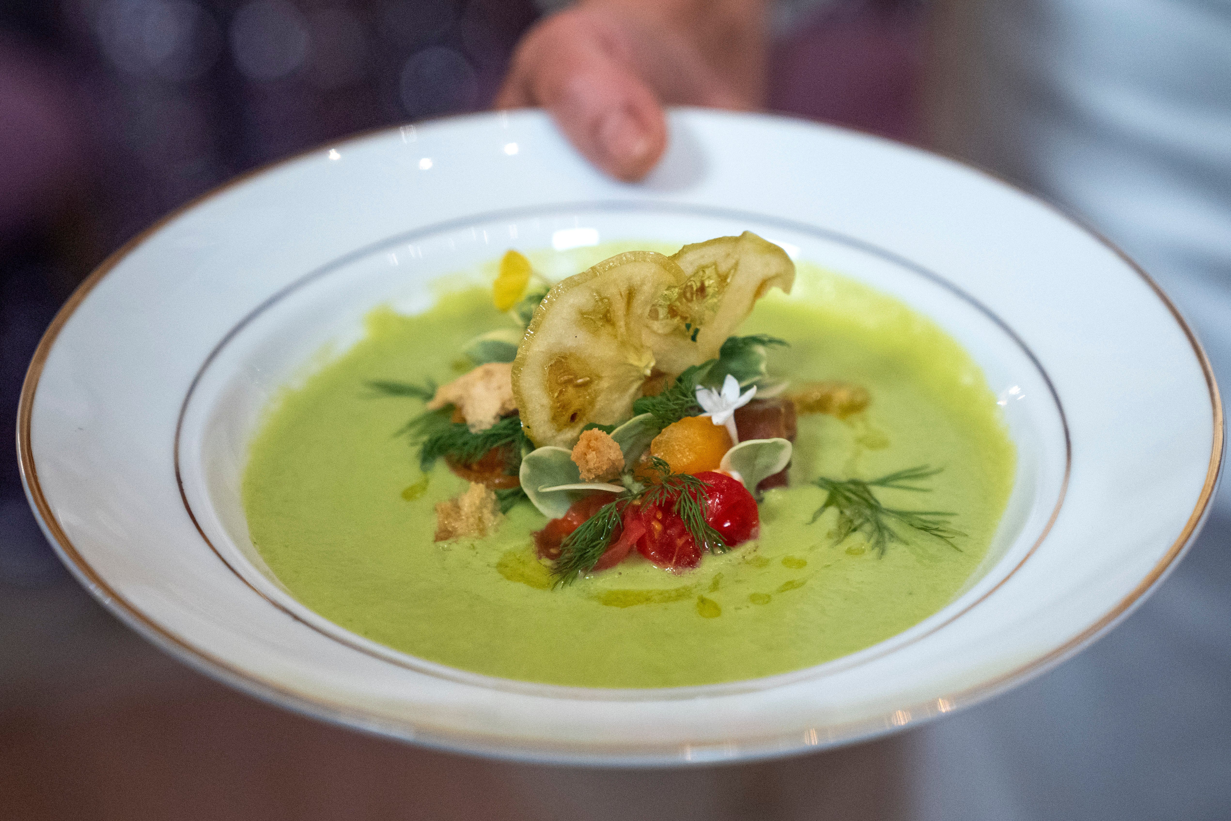 The first course, a chilled heirloom tomato soup with sourdough crisps and arbequina olive oil is shown by White House Executive ChefCris Comerford on Wednesday