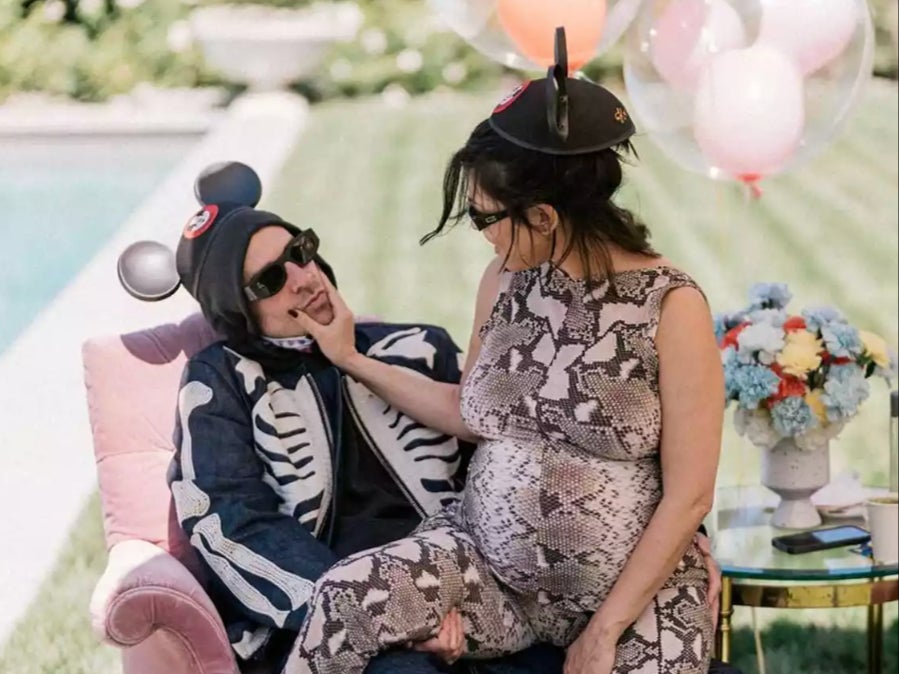 Travis Barker and Kourtney Kardashian Barker posed together during their Disneyland-themed baby shower in September 2023 (@kourtneykardash/Instagram)