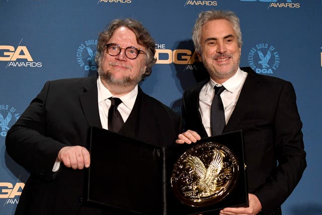 <p>Guillermo del Toro (L) and 2018 DGA Feature Film Award winner for ‘Roma’ Alfonso Cuaron pose in the press room during the 71st Annual Directors Guild Of America Awards in 2019</p>