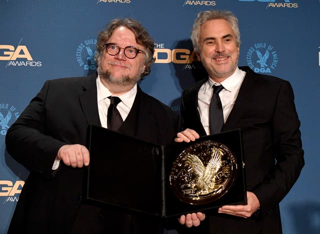 <p>Guillermo del Toro (L) and 2018 DGA Feature Film Award winner for ‘Roma’ Alfonso Cuaron pose in the press room during the 71st Annual Directors Guild Of America Awards in 2019</p>