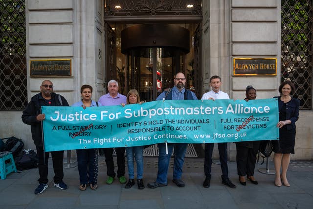 <p>File photo: Members of the Justice For Subpostmasters Alliance hold a banner after former Post Office chief executive Paula Vennells arrived</p>