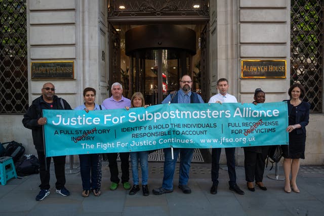 <p>File photo: Members of the Justice For Subpostmasters Alliance hold a banner after former Post Office chief executive Paula Vennells arrived</p>