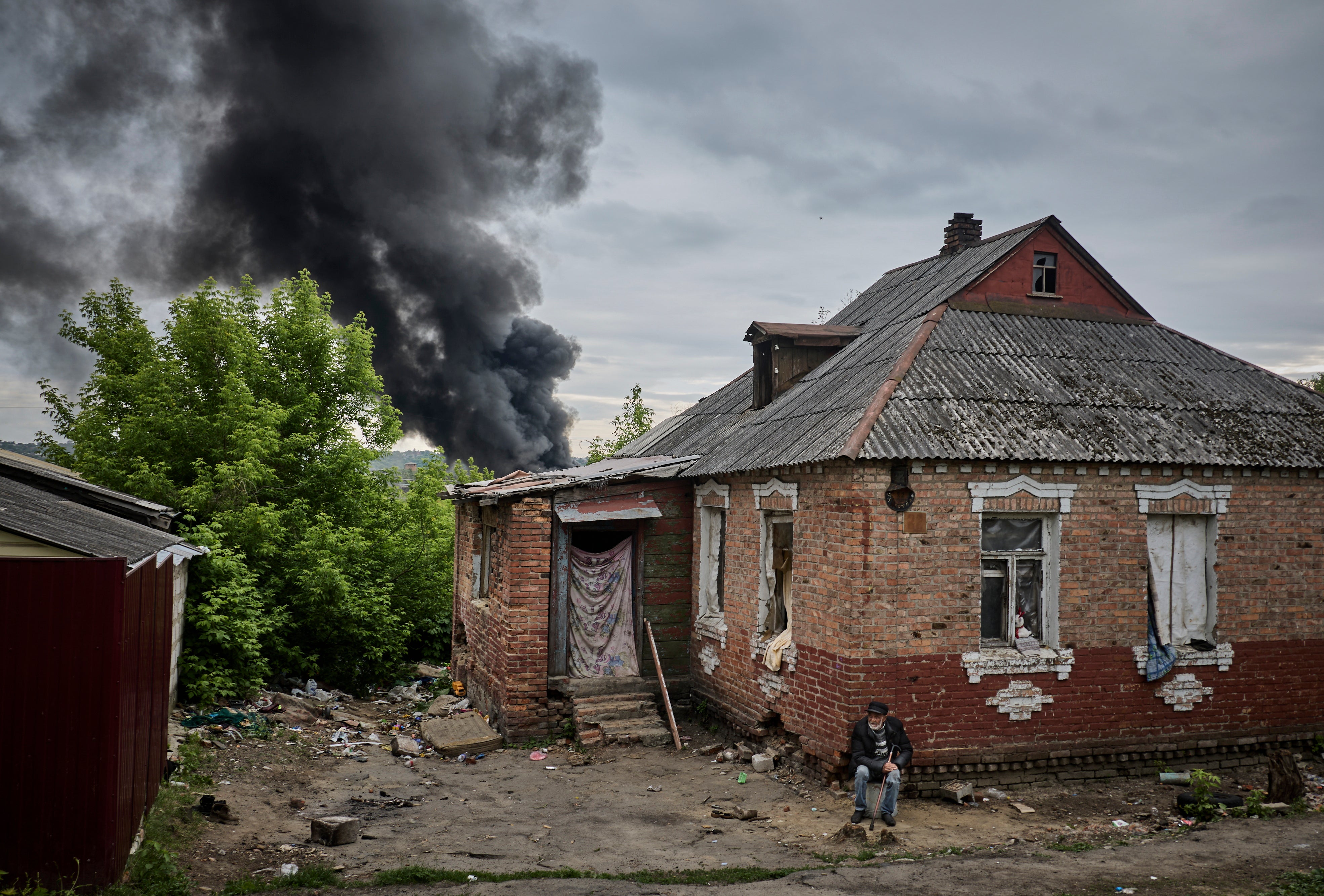 Smoke rises above a damaged building after shelling, on the outskirts of Kharkiv