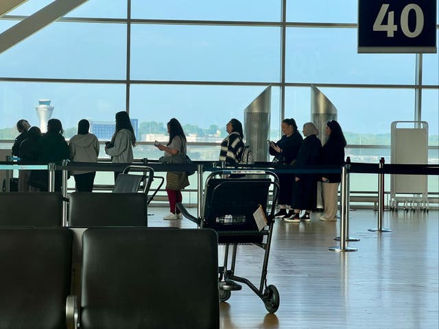 <p>Going places: Passengers at Birmingham airport, where 15 per cent more people are expected than over the same spell in 2023</p>