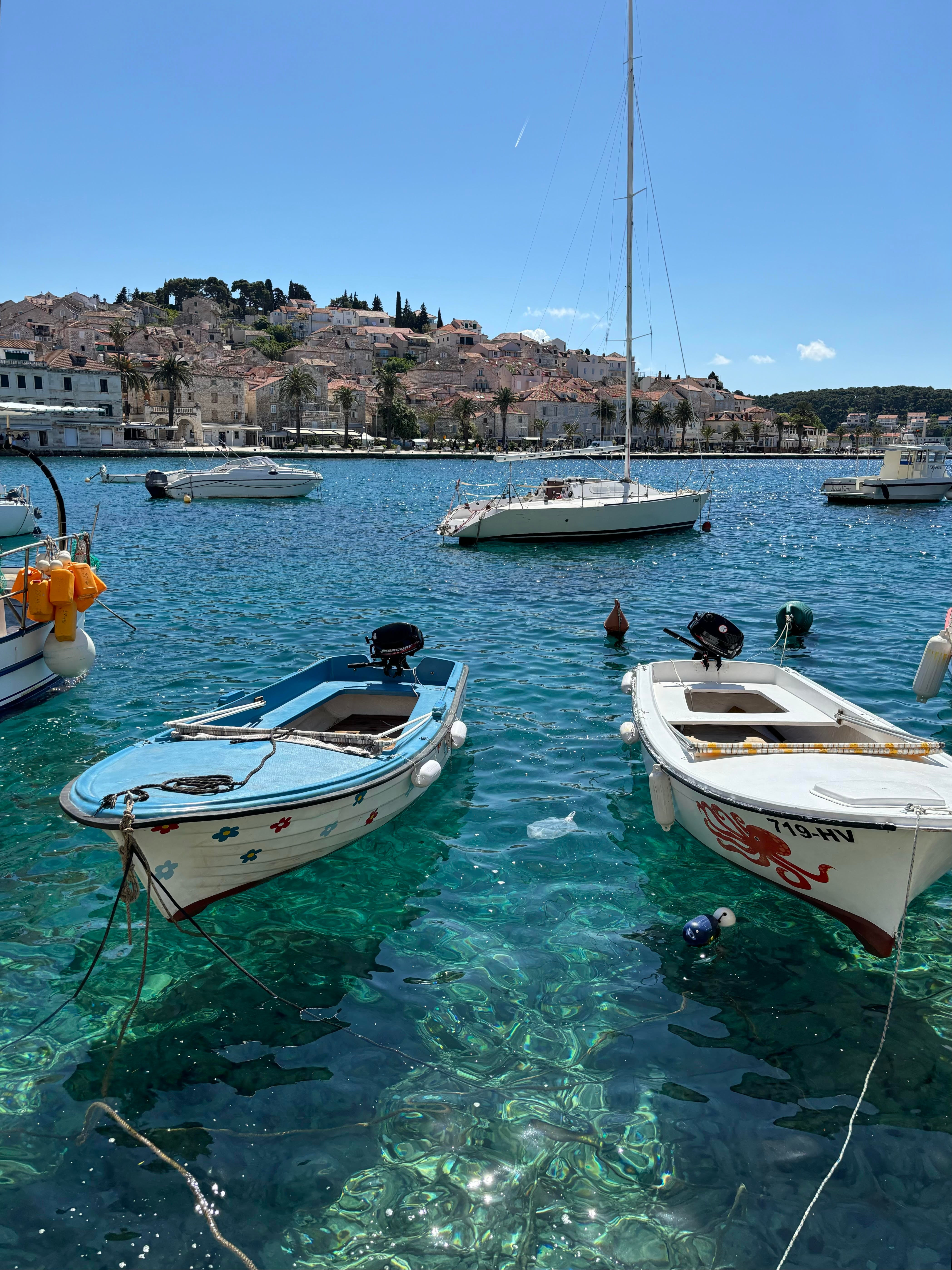 Charming scenes of boats bobbing in tranquil blue waters await visitors to Hvar’s waterfront