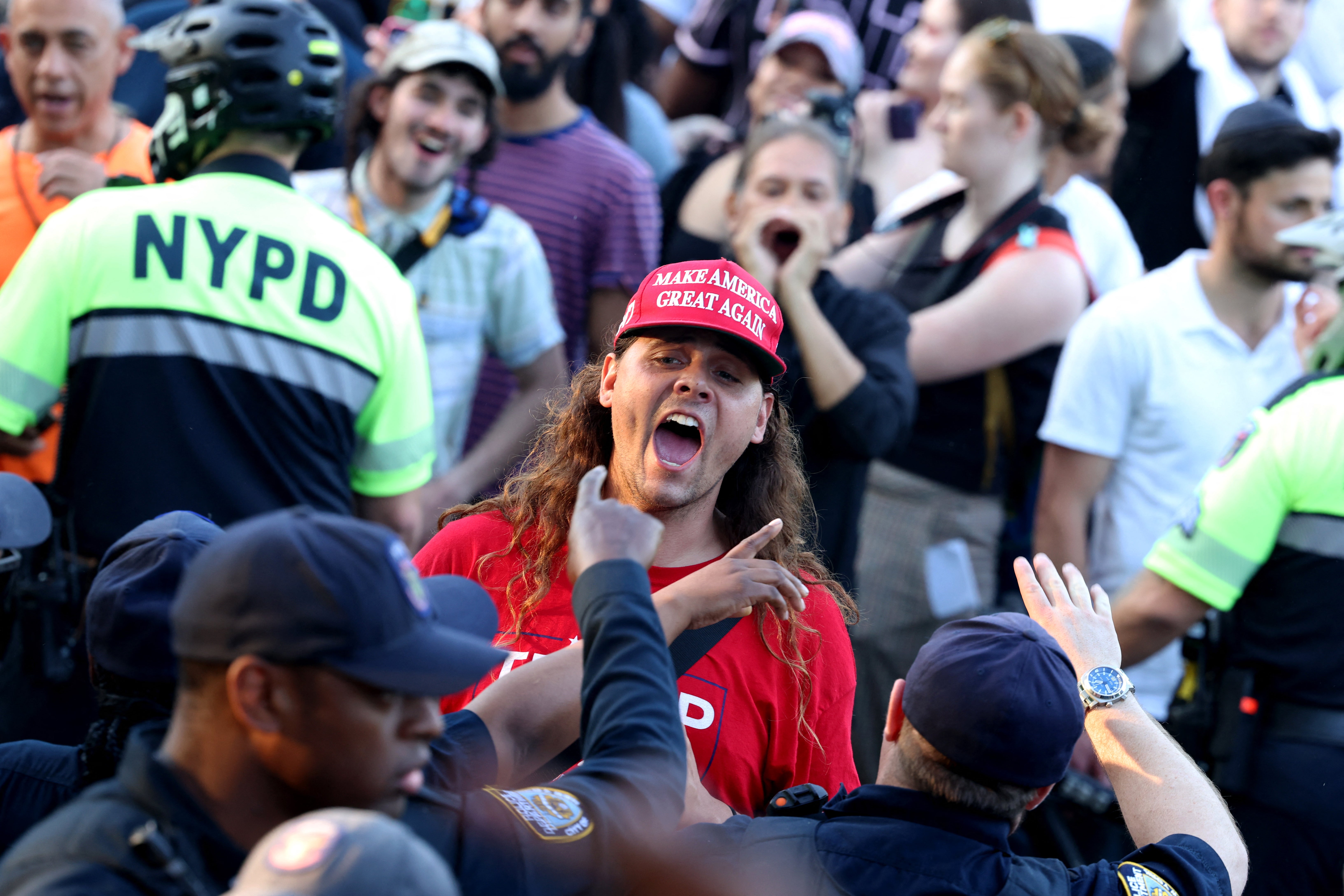A Trump supporter confronts protestors during the campaign rally in the South Bronx in New York City on 23 May