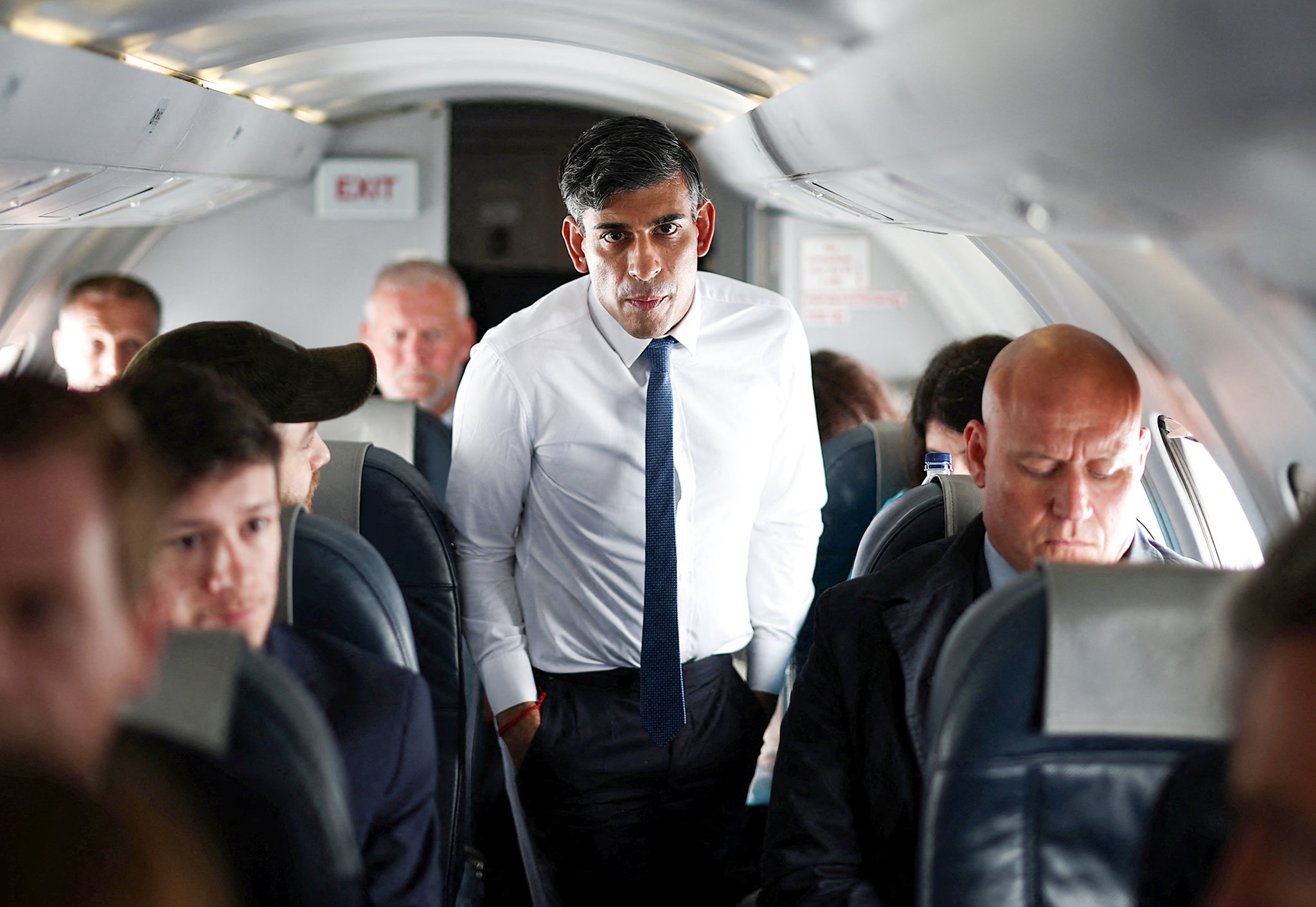 Sunak walks towards journalists on the plane