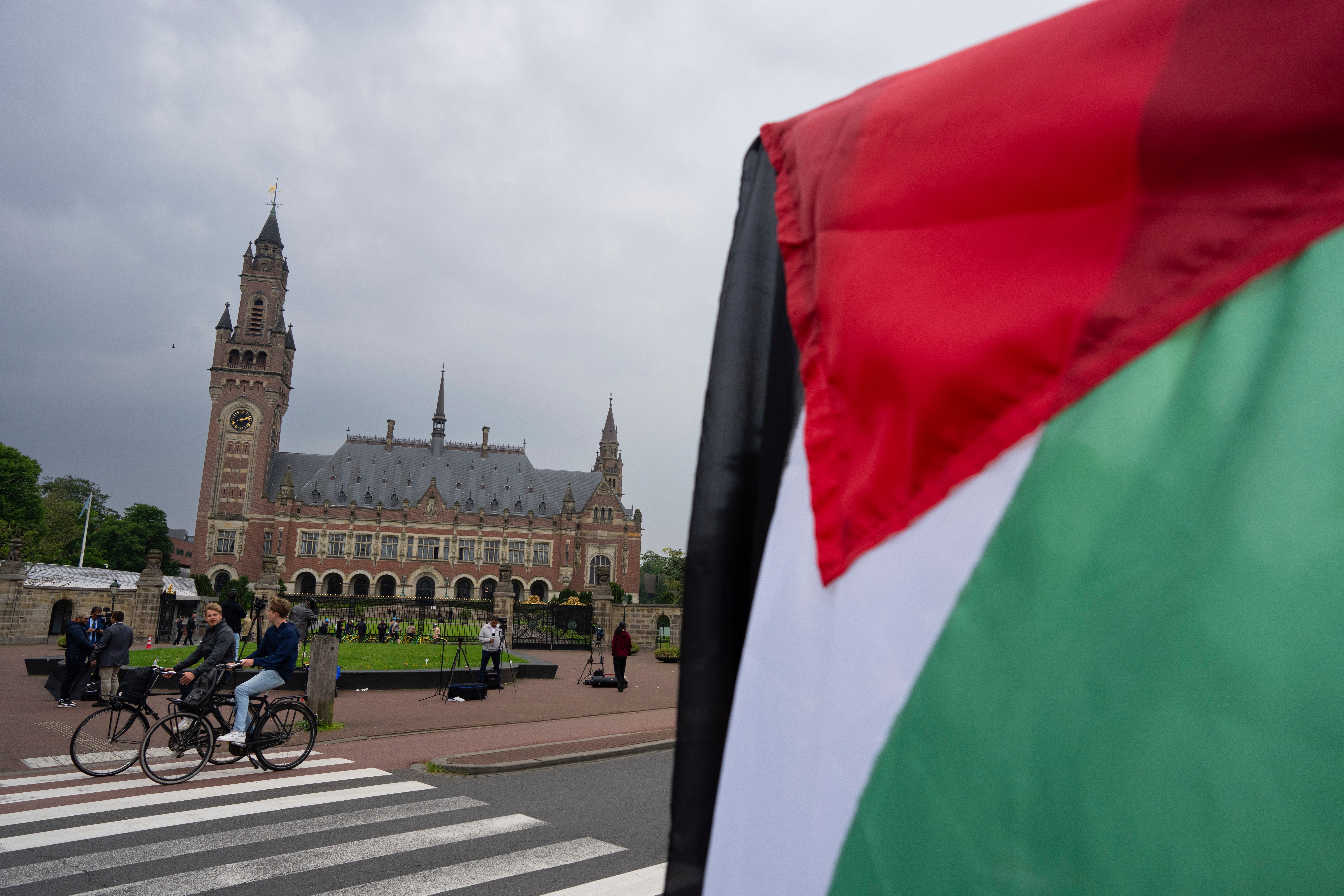The court at The Hague, with demonstrators carrying Palestinian flags