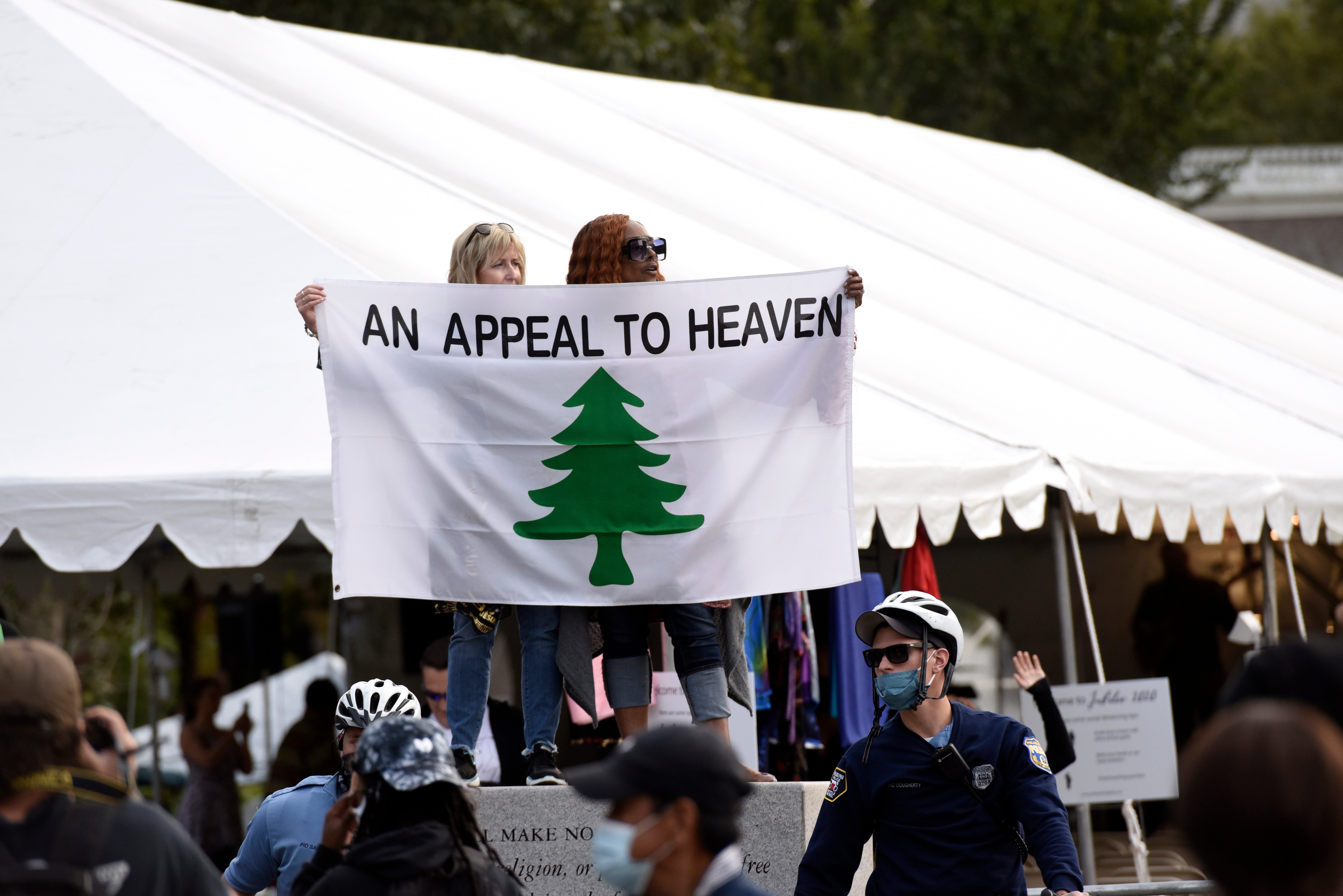 People carry an "Appeal To Heaven" flag as they gather at Independence Mall to support president Donald Trump during a visit to the National Constitution Center to participate in the ABC News town hall, on 15 September 2020 in Philadelphia