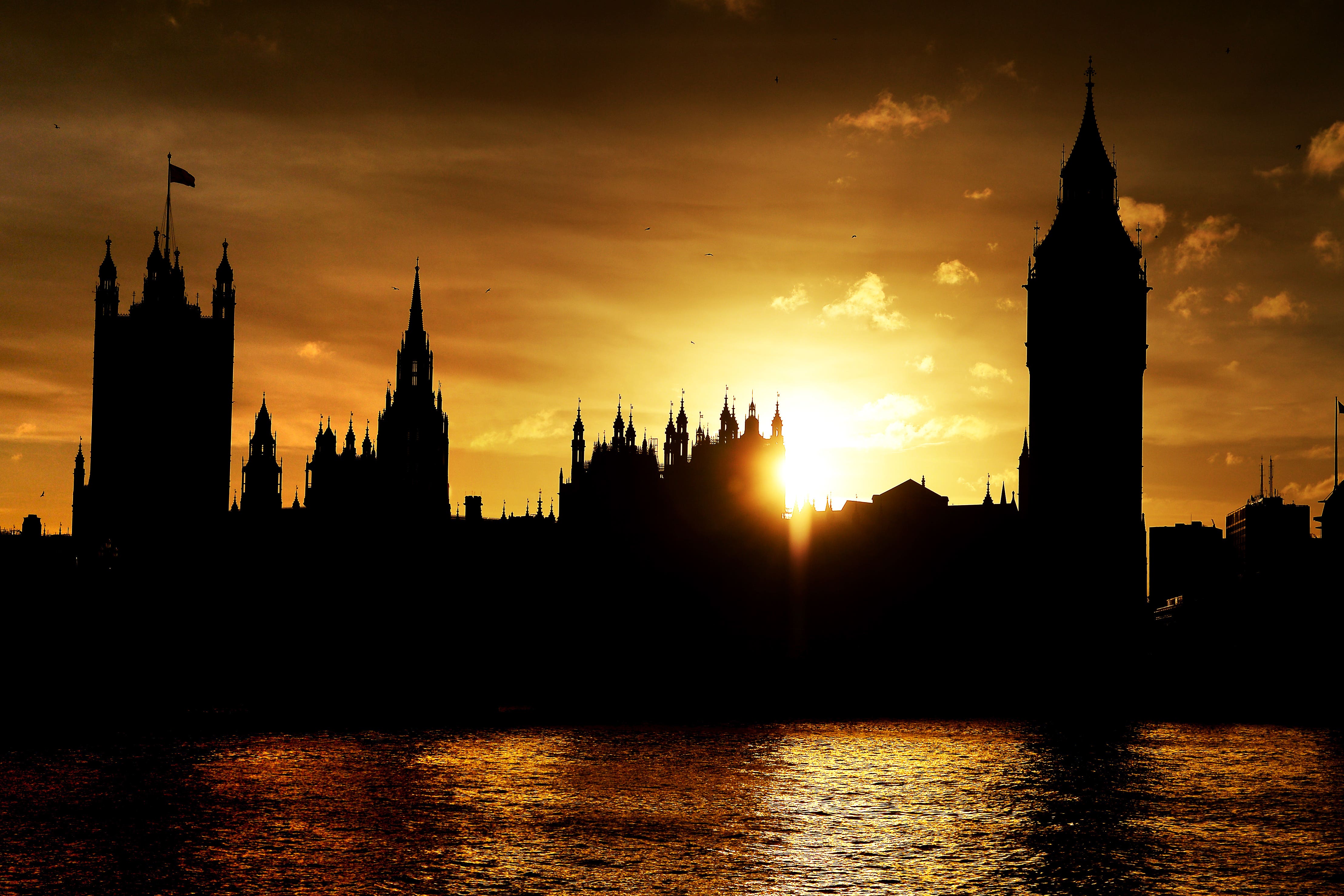 The sun sets behind the Houses of Parliament (Andrew Matthews/PA)