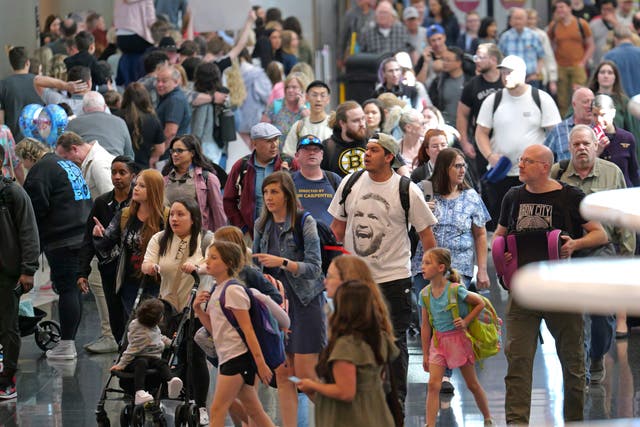 Travelers walk through Salt Lake City International Airport on May 24, in Salt Lake City.