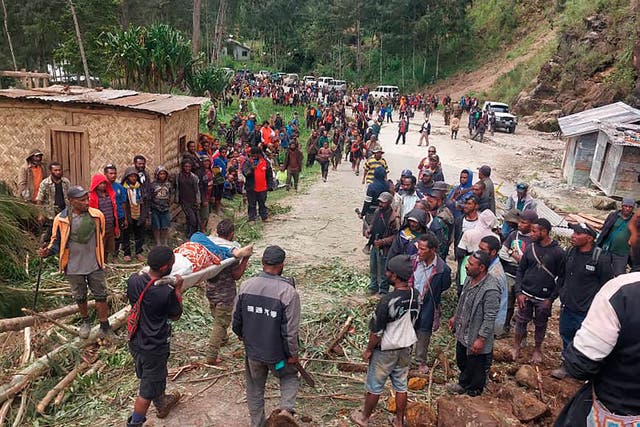 <p>An injured person is carried on a stretcher after a landslide in Yambali village of Papua New Guinea</p>