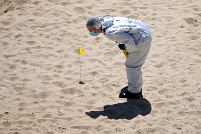 <p>Forensics officers at the beach in Bournemouth following the fatal incident </p>