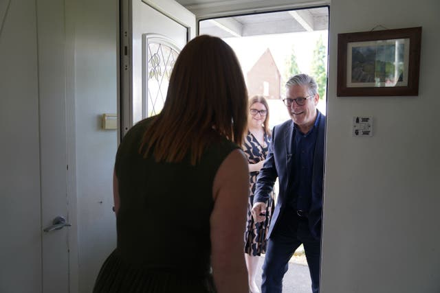 Labour leader Sir Keir Starmer and the party’s candidate for Stafford Leigh Ingham campaign on the doorsteps (Jacob King/PA)