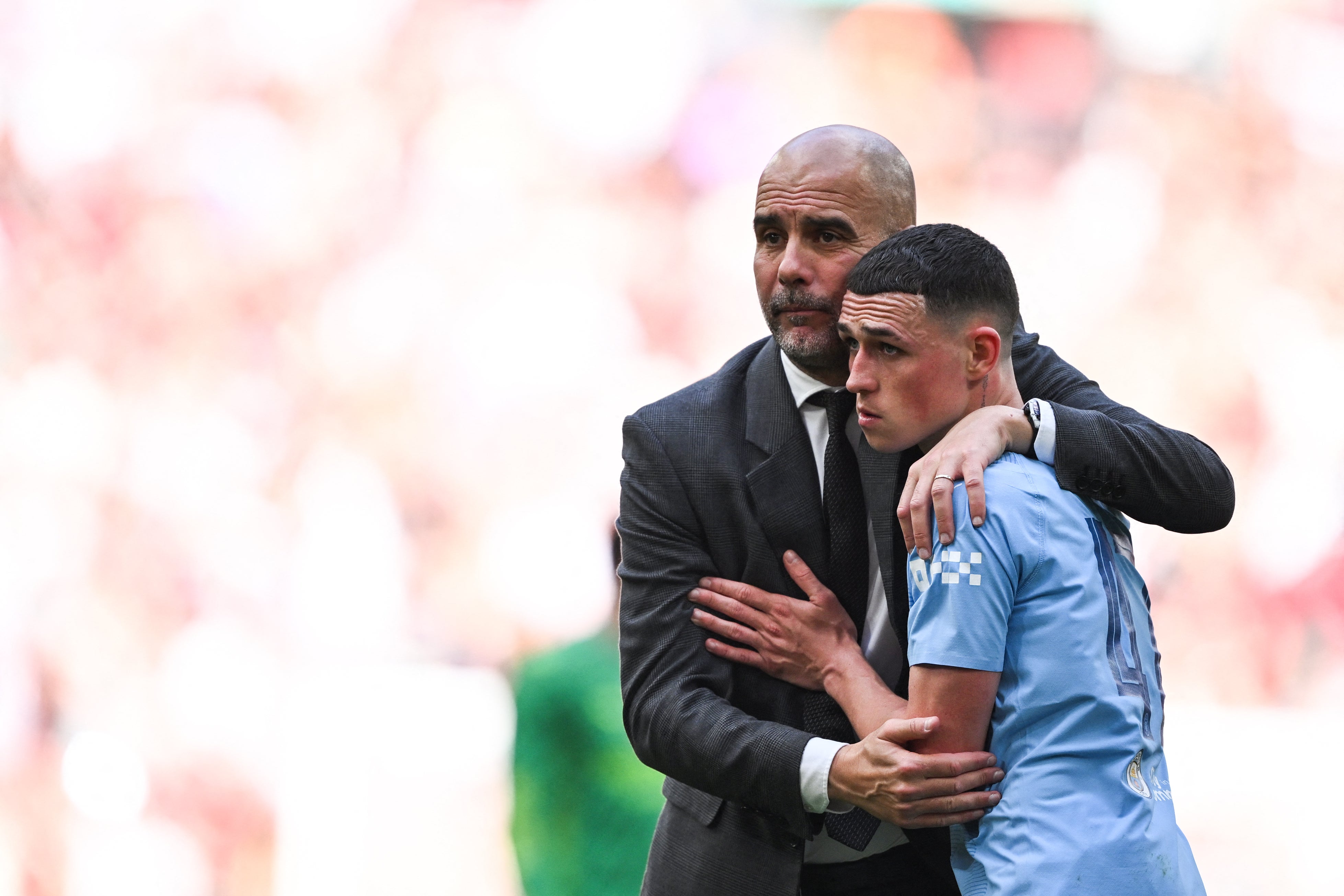 Pep Guardiola consoles Phil Foden after defeat in the Cup final
